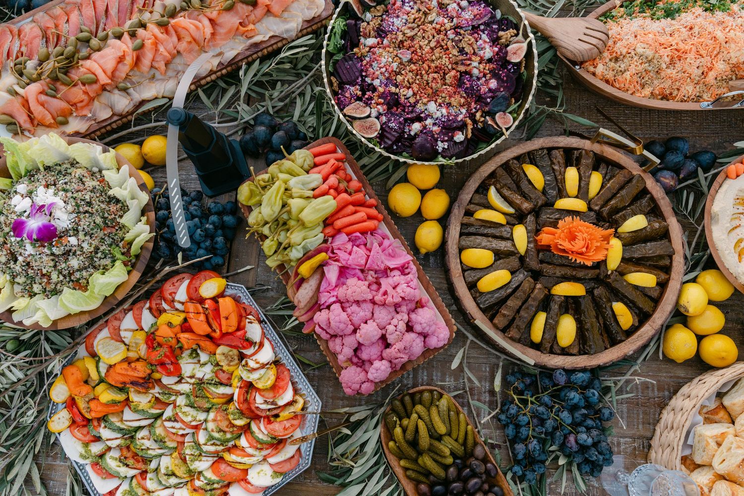 Colorful grazing table filled with Mediterranean appetizers, fruits, and charcuterie.