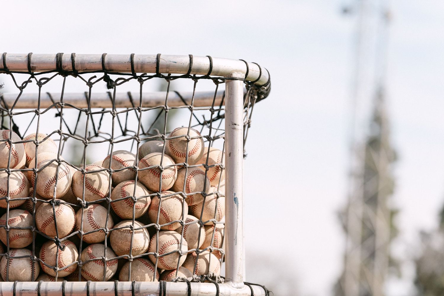 Wire mesh storage containers filled with fresh brown eggs at an outdoor farmers market or farm stand.