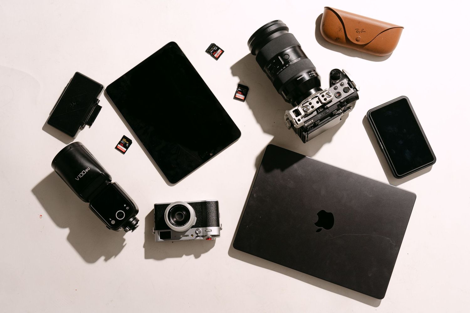 Minimalist black and white product photography featuring beauty product boxes and containers casting dramatic shadows.