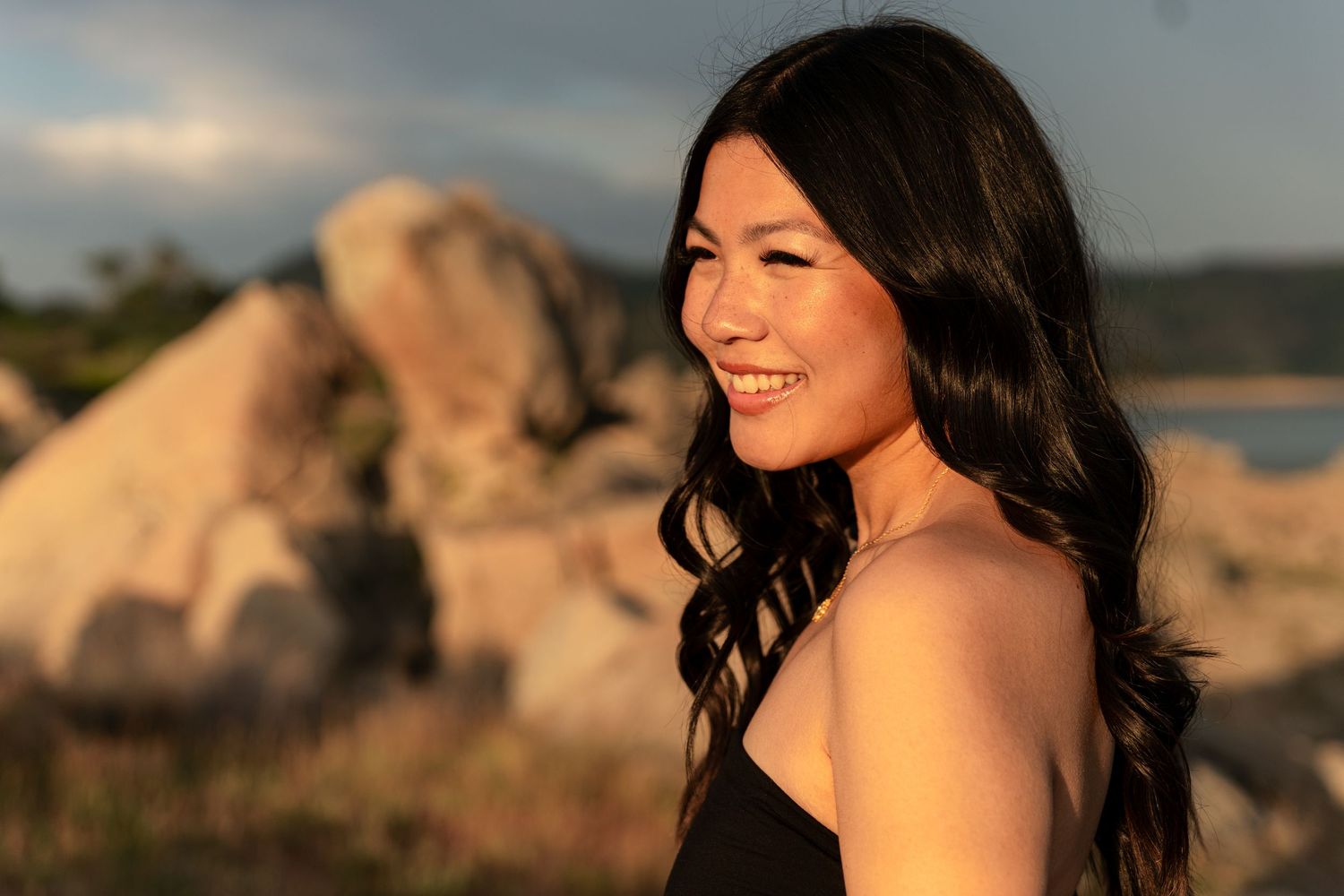 Natural light portrait series captured during golden hour against rocky backdrop.