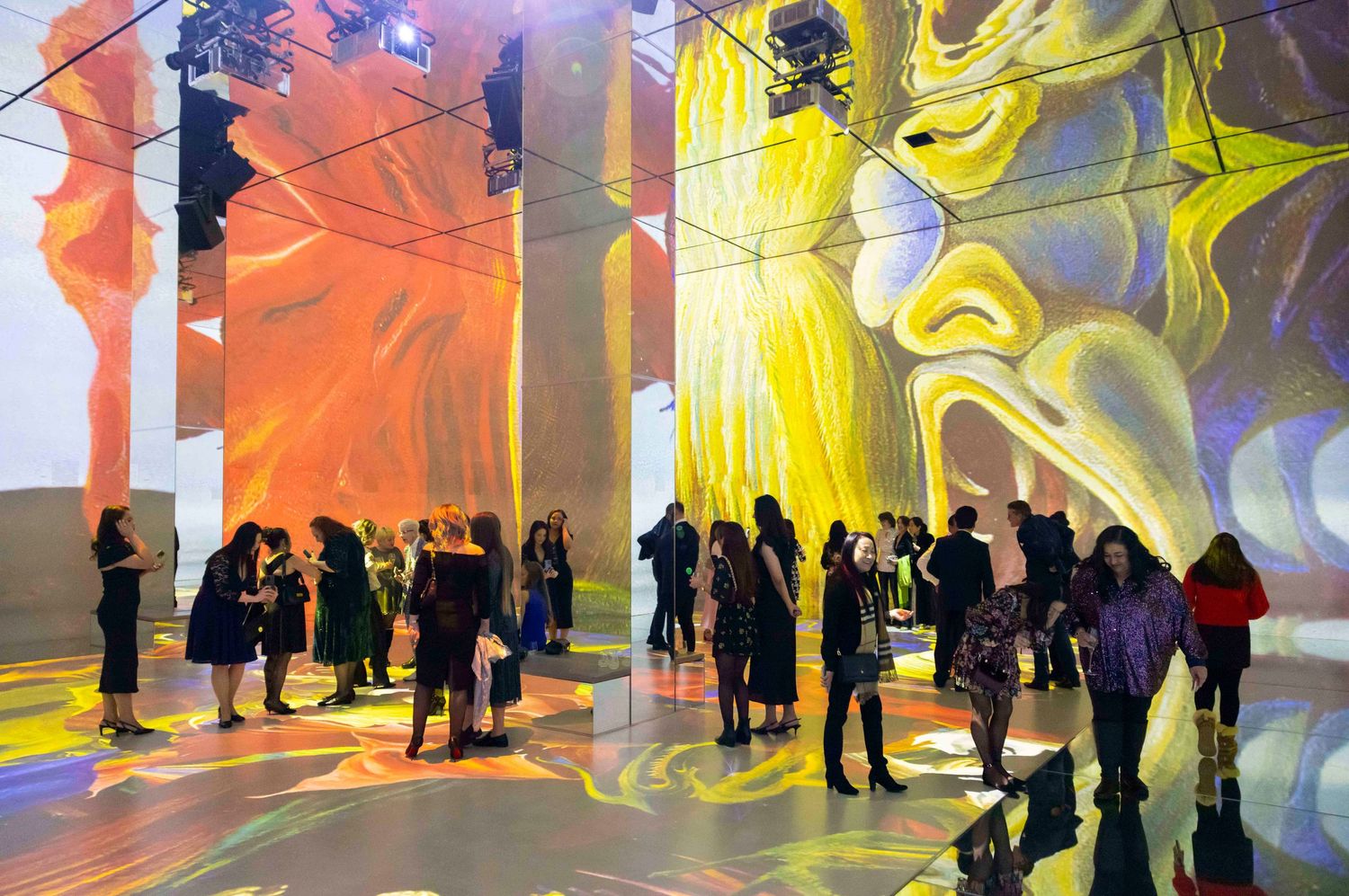 Art installation with colorful projected visuals and silhouetted visitors viewing the exhibition. London Event Photographer