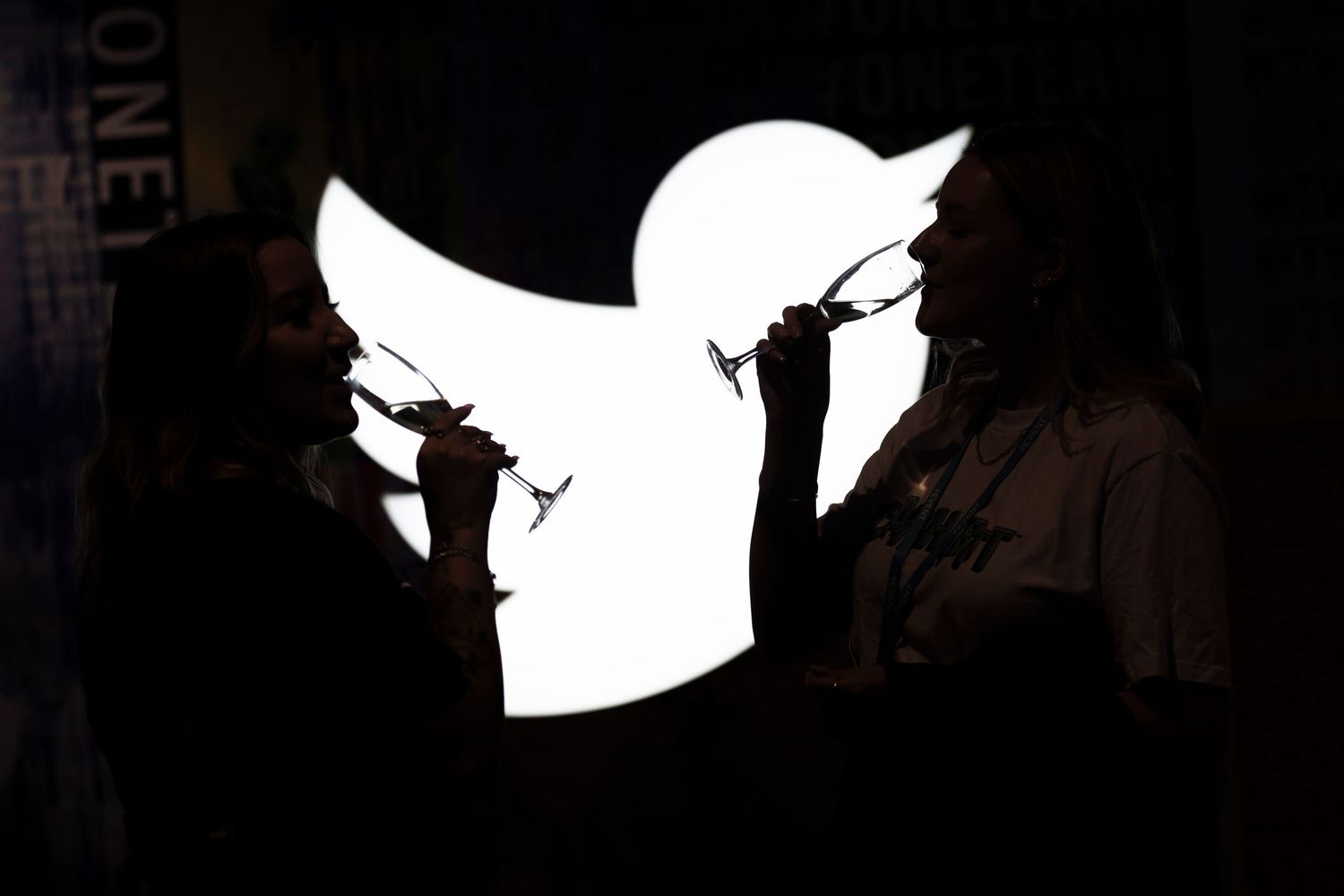 High contrast silhouettes of figures against dark background creating artistic composition. London Event Photographer