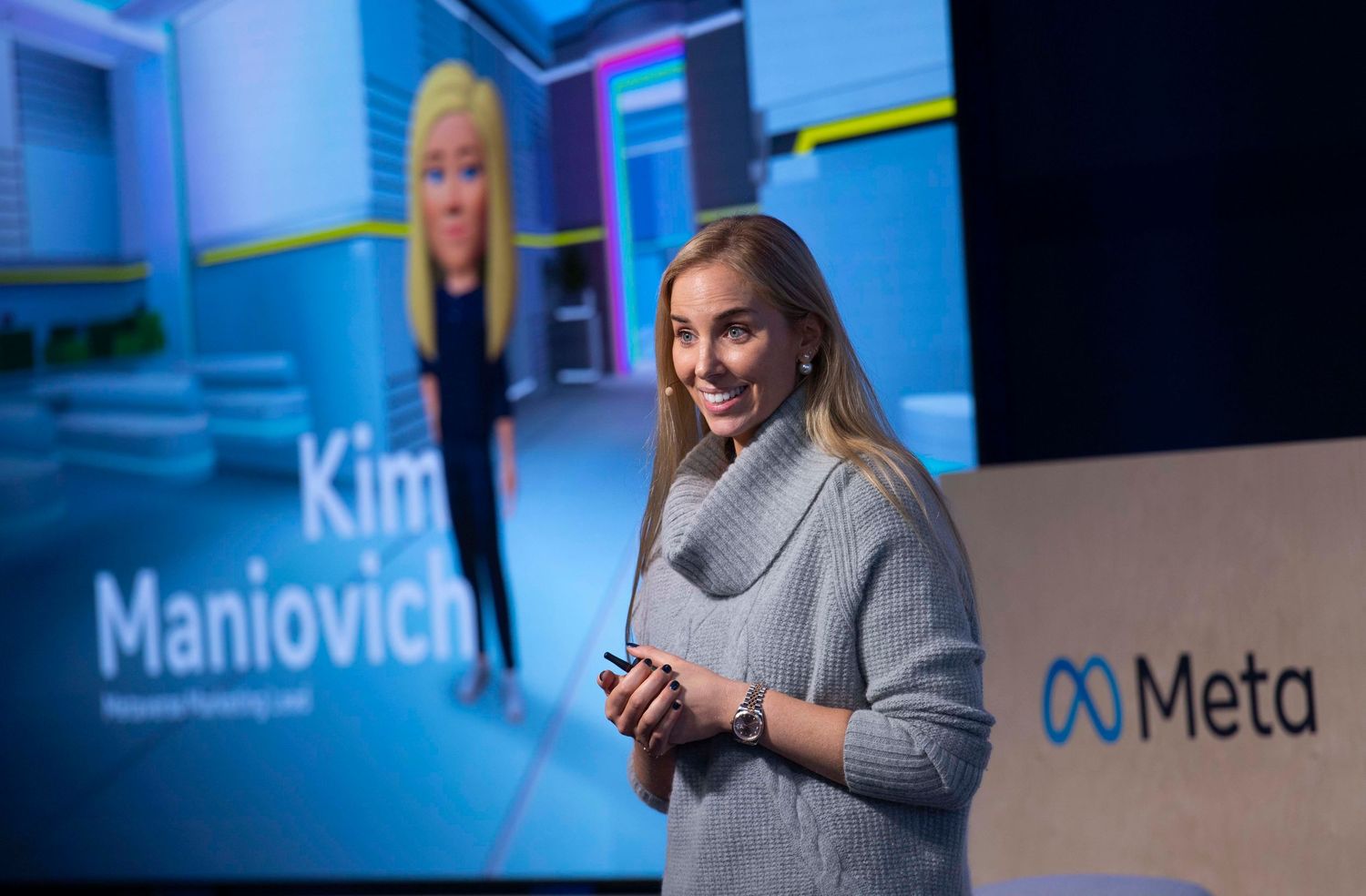 Speaker presenting at technology conference with Meta logo displayed on blue screens. London Event Photographer