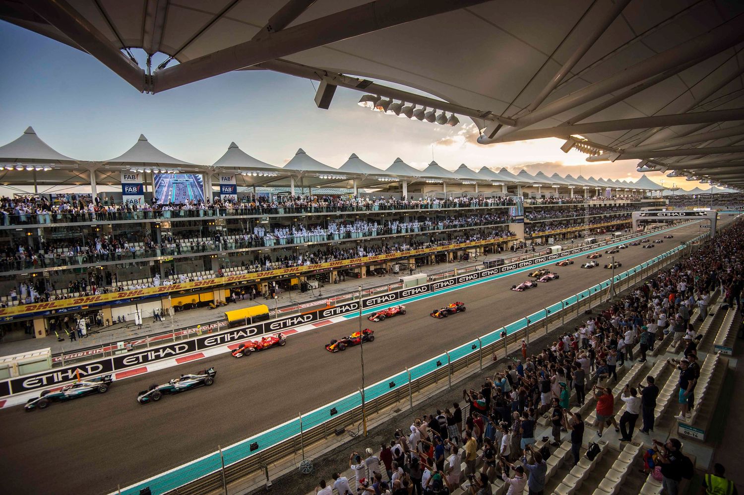 Panoramic view of a modern racing circuit with grandstands and track facilities under blue sky. London Event Photographer