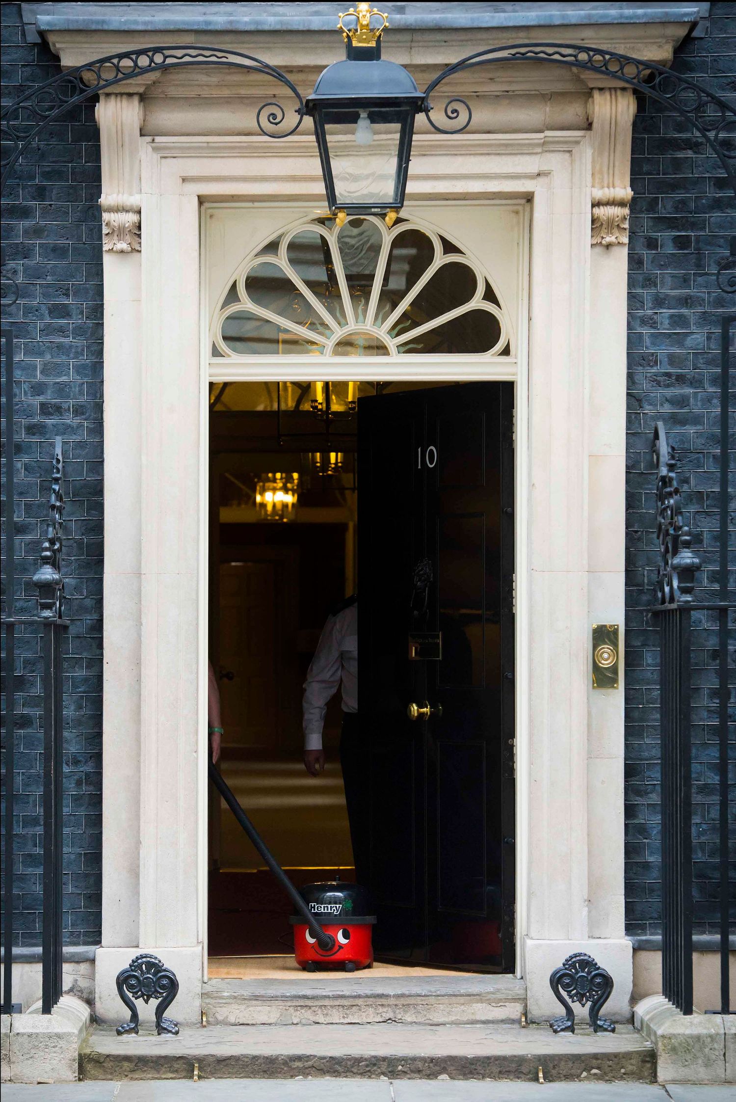 Traditional black brick building facade with white Georgian doorways and ornate architectural details. London Event Photographer