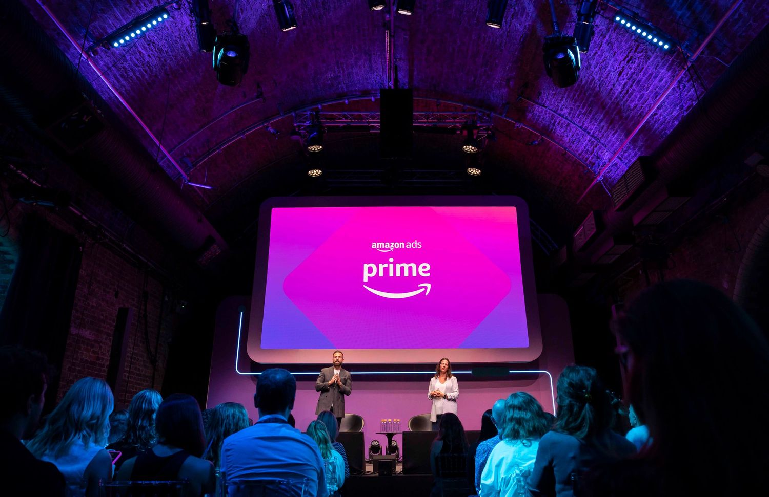 Purple-lit stage with Amazon Prime branding displayed on large screens. London Event Photographer
