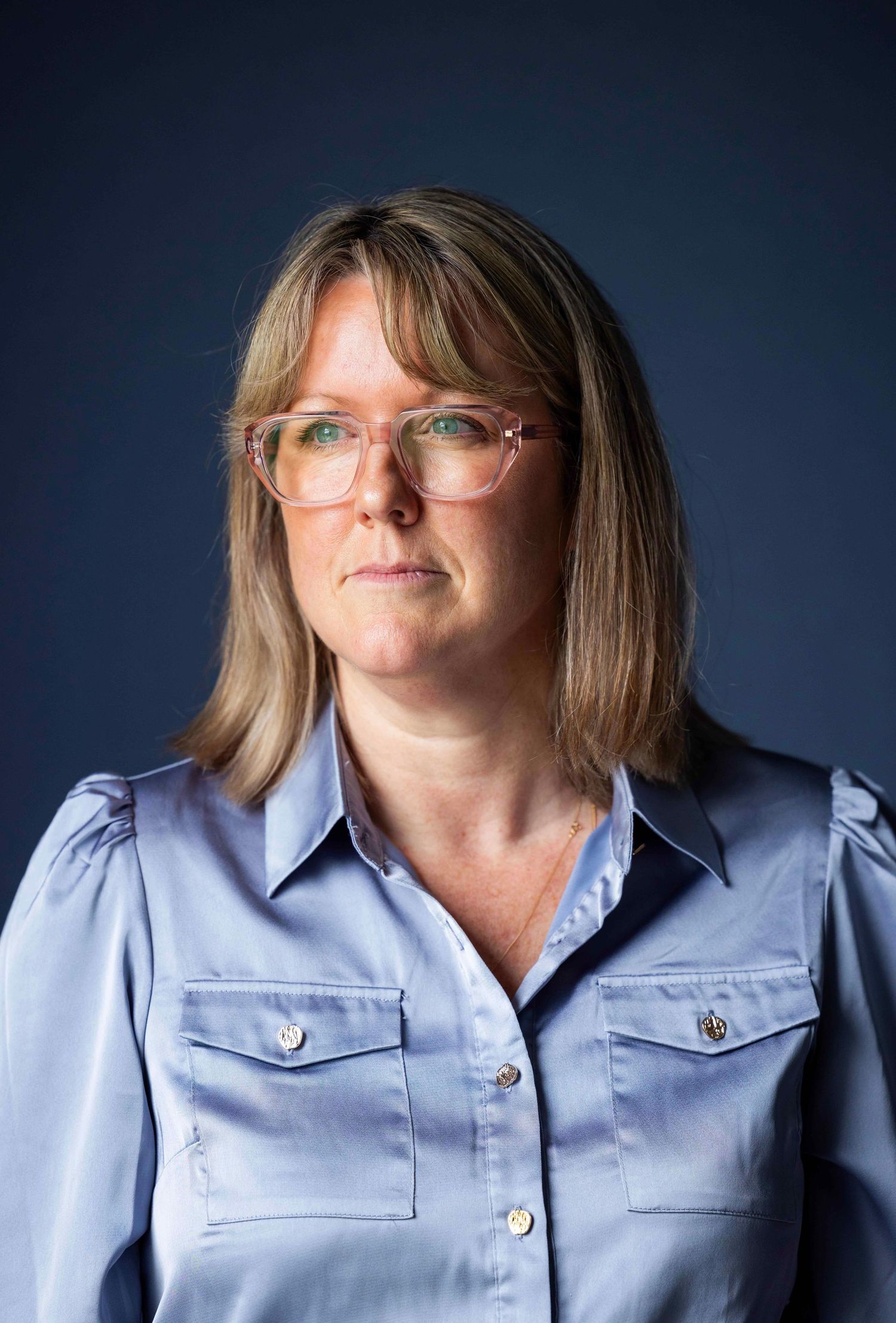 Portrait series in light blue button-up shirt against dark background. London Event Photographer