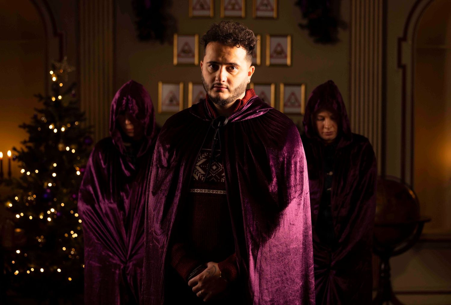 Dark purple-lit indoor scene with holiday lights and decorations. London Event Photographer