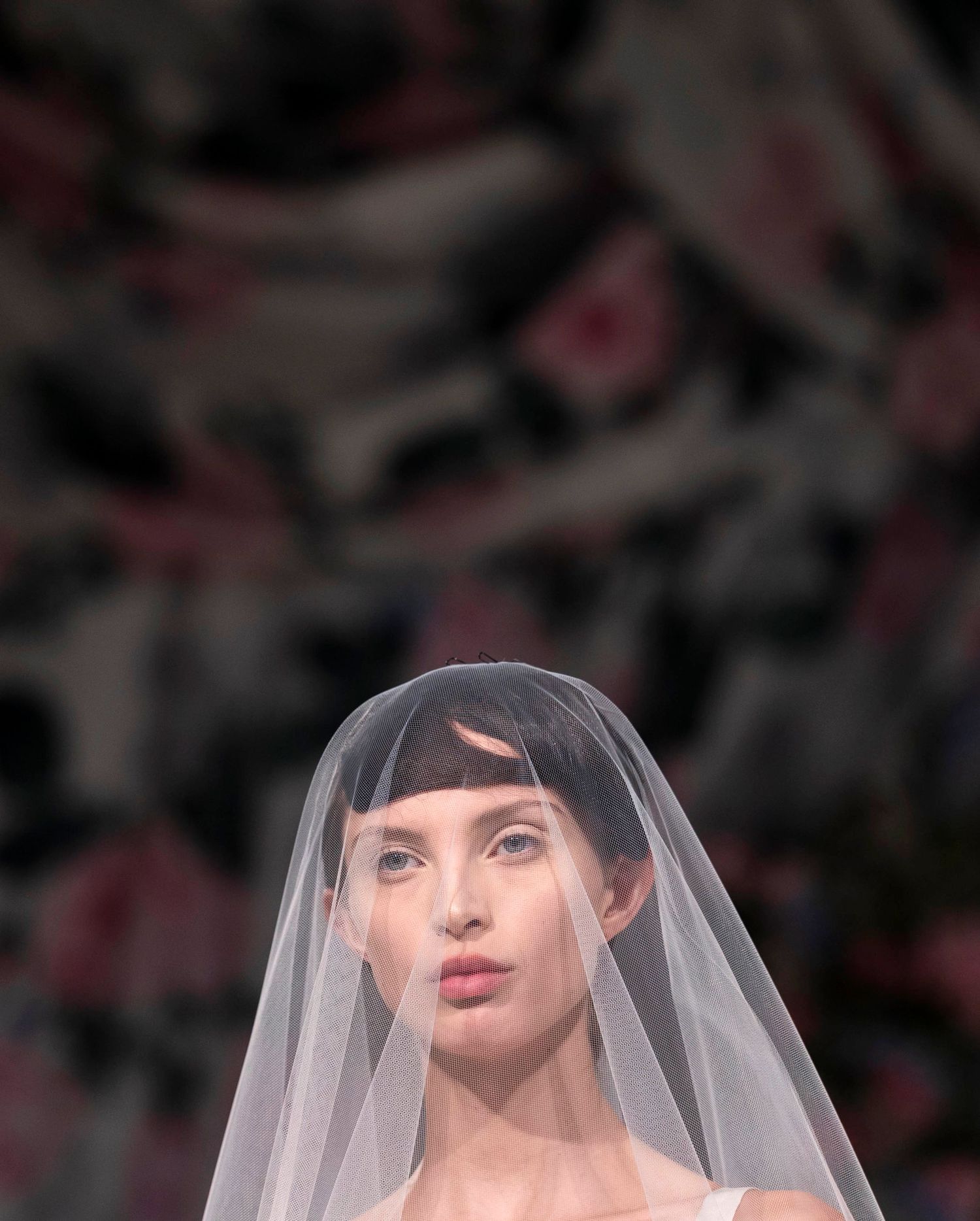 Artistic bridal portraits featuring a white veil against a dark floral background. London Event Photographer