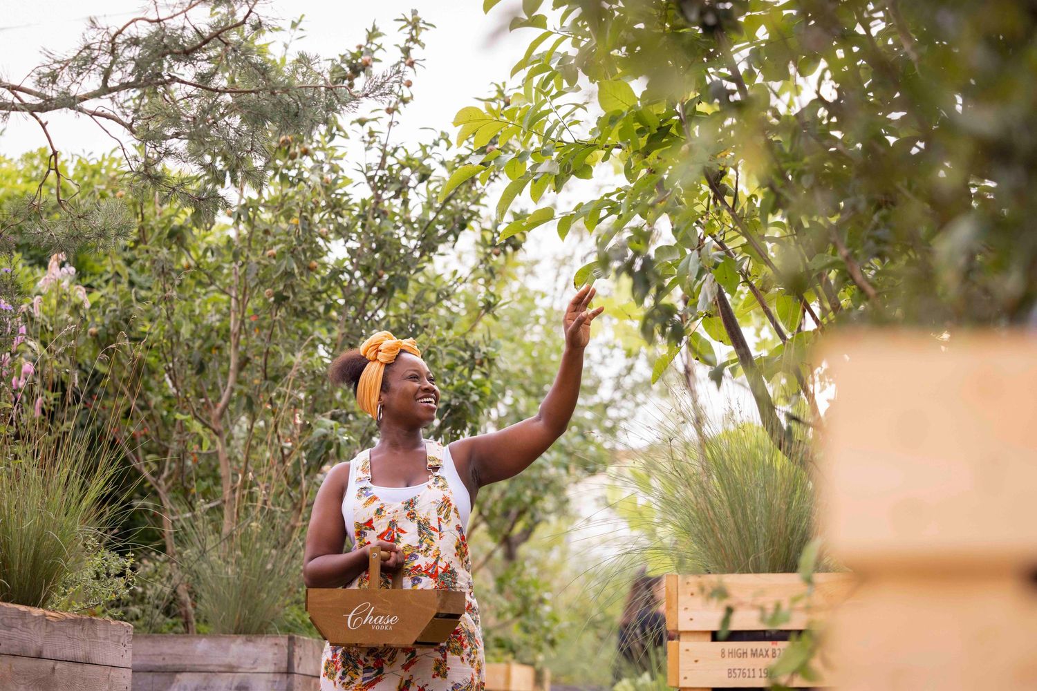People working outdoors in a lush garden setting with natural lighting. London Event Photographer