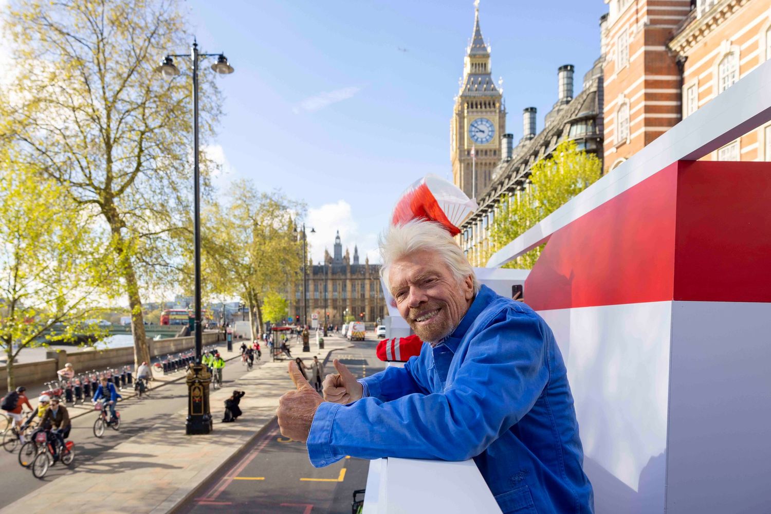 Street scene with English flags and Big Ben visible in the background on a sunny day. London Event Photographer
