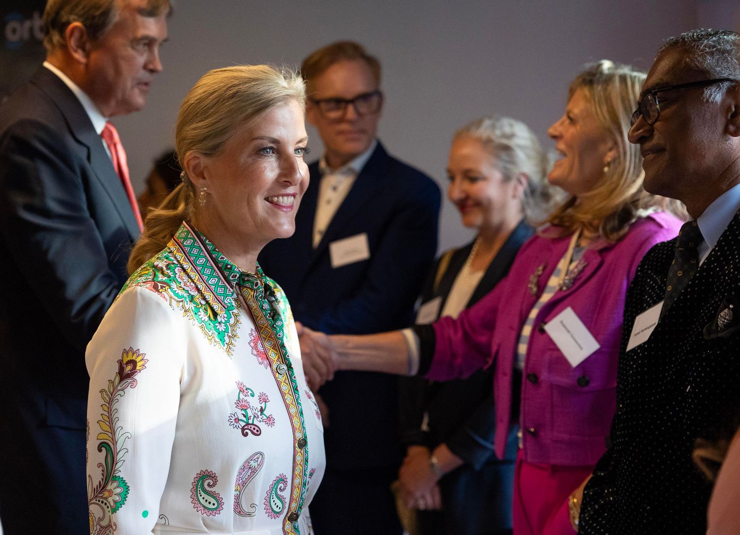 Professional networking event with attendees mingling in formal business attire. London Event Photographer