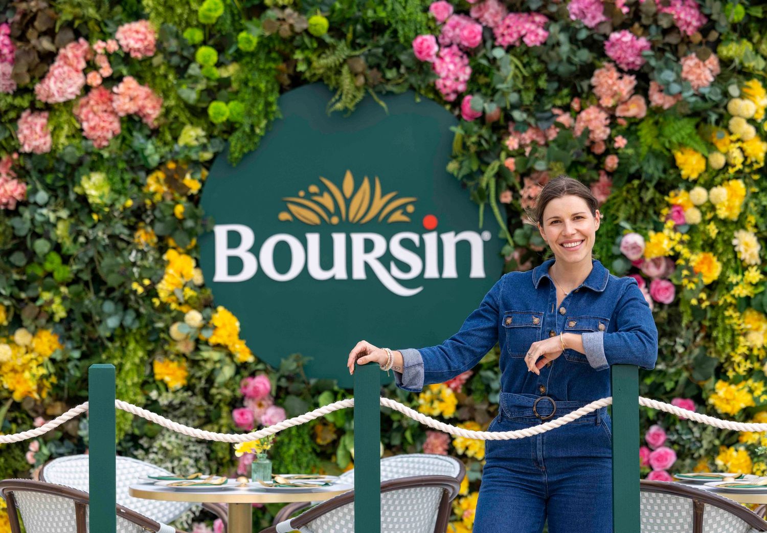 Boursin cheese brand display with floral backdrop and presenter. London Event Photographer