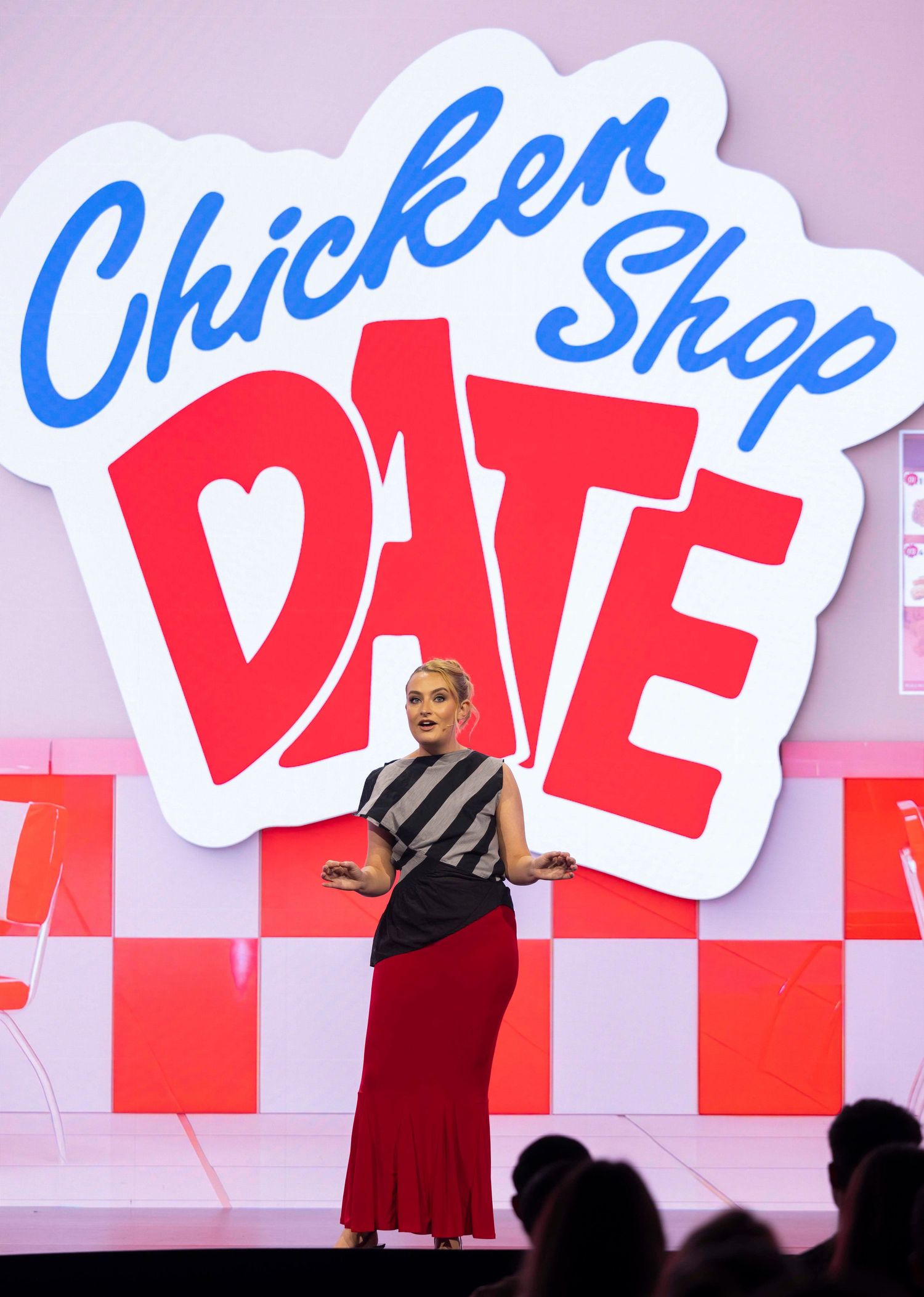 Large red and white text display on stage at promotional event. London Event Photographer