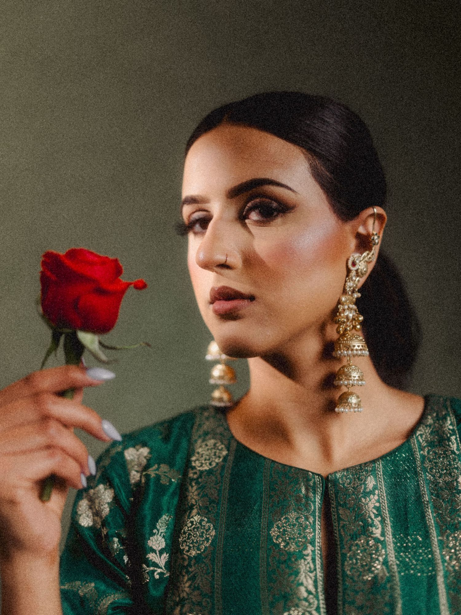 Bride holding flowers during wedding portrait session in natural light