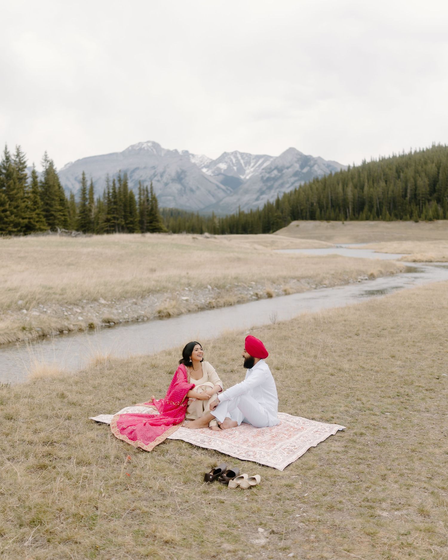 Indian wedding couple portrait in Banff mountains during golden hour