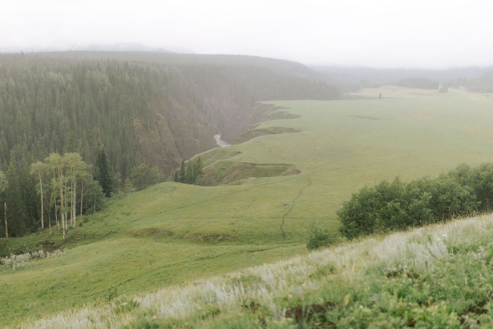 Couple photographed against an open Alberta landscape by Bahga Films
