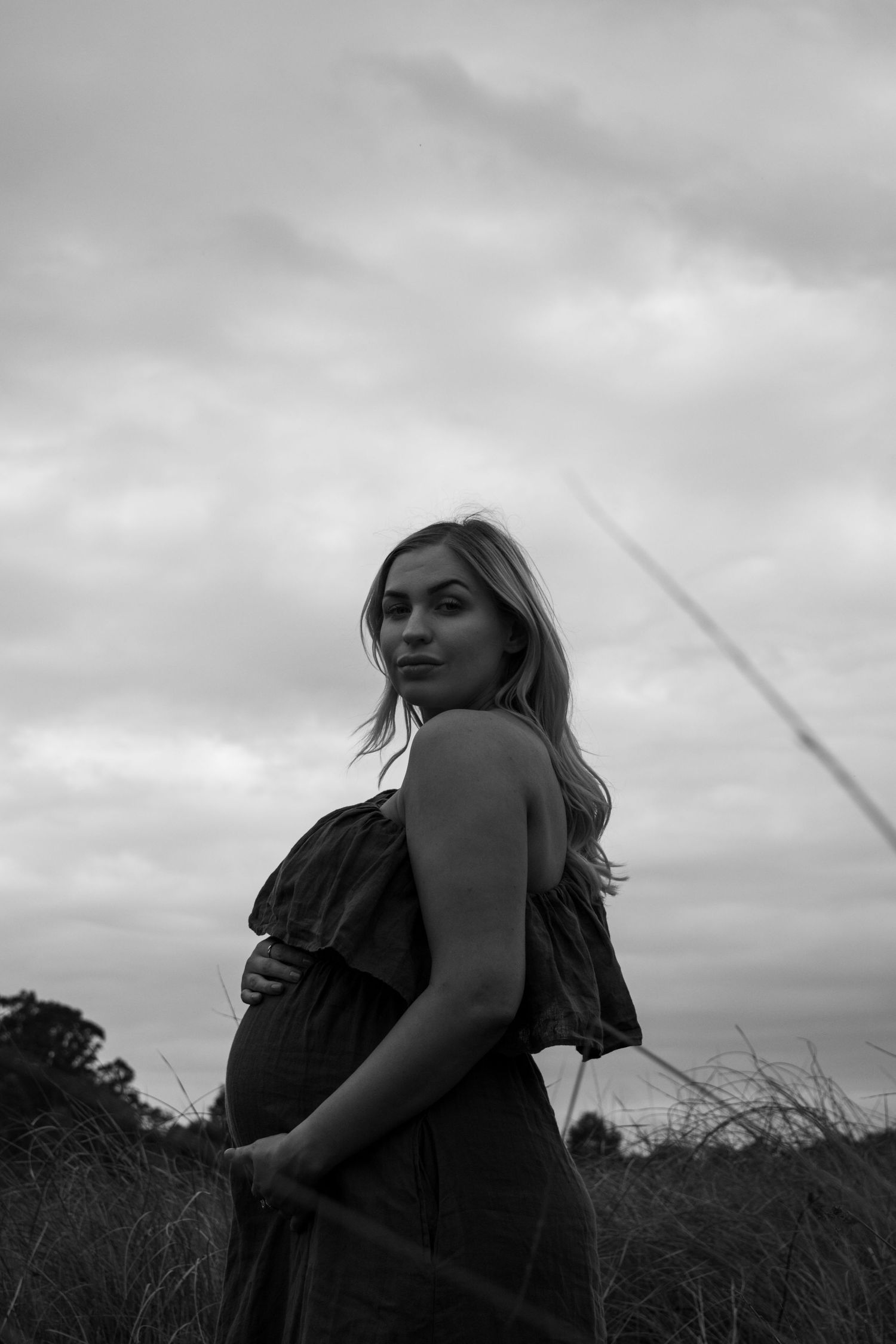 A black and white artistic photo series showing a person in silhouette against a moody cloudy sky.