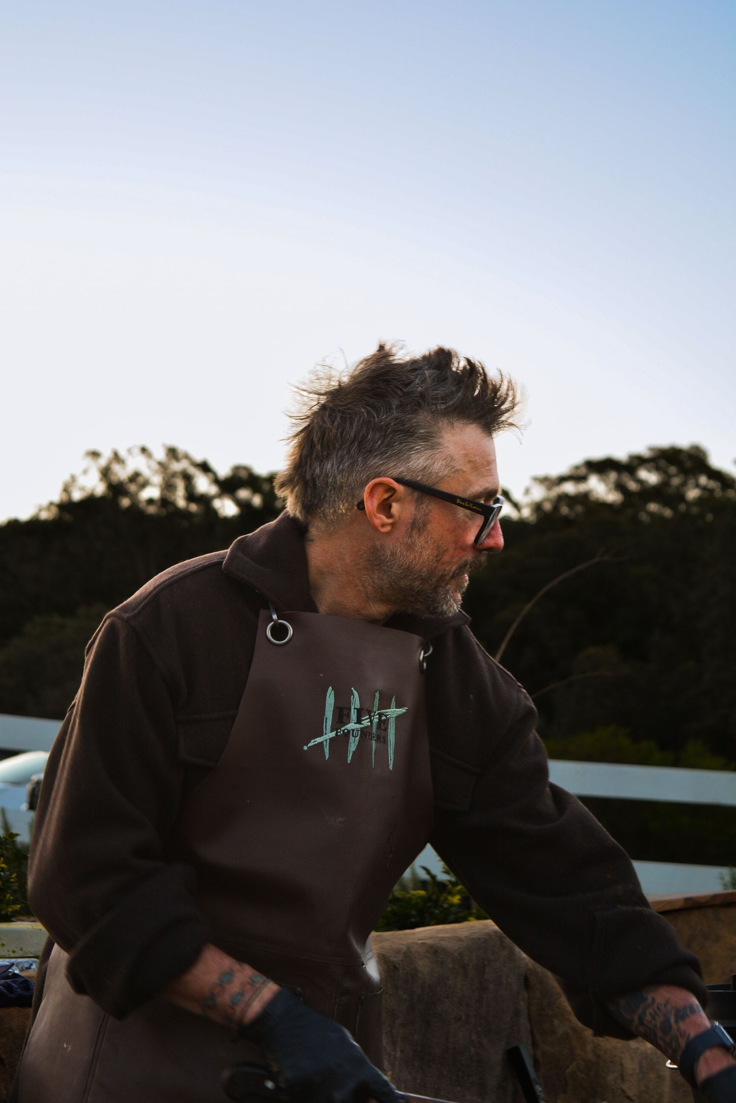 Person wearing a dark brown hoodie shown in a series of three connected outdoor shots at sunset.