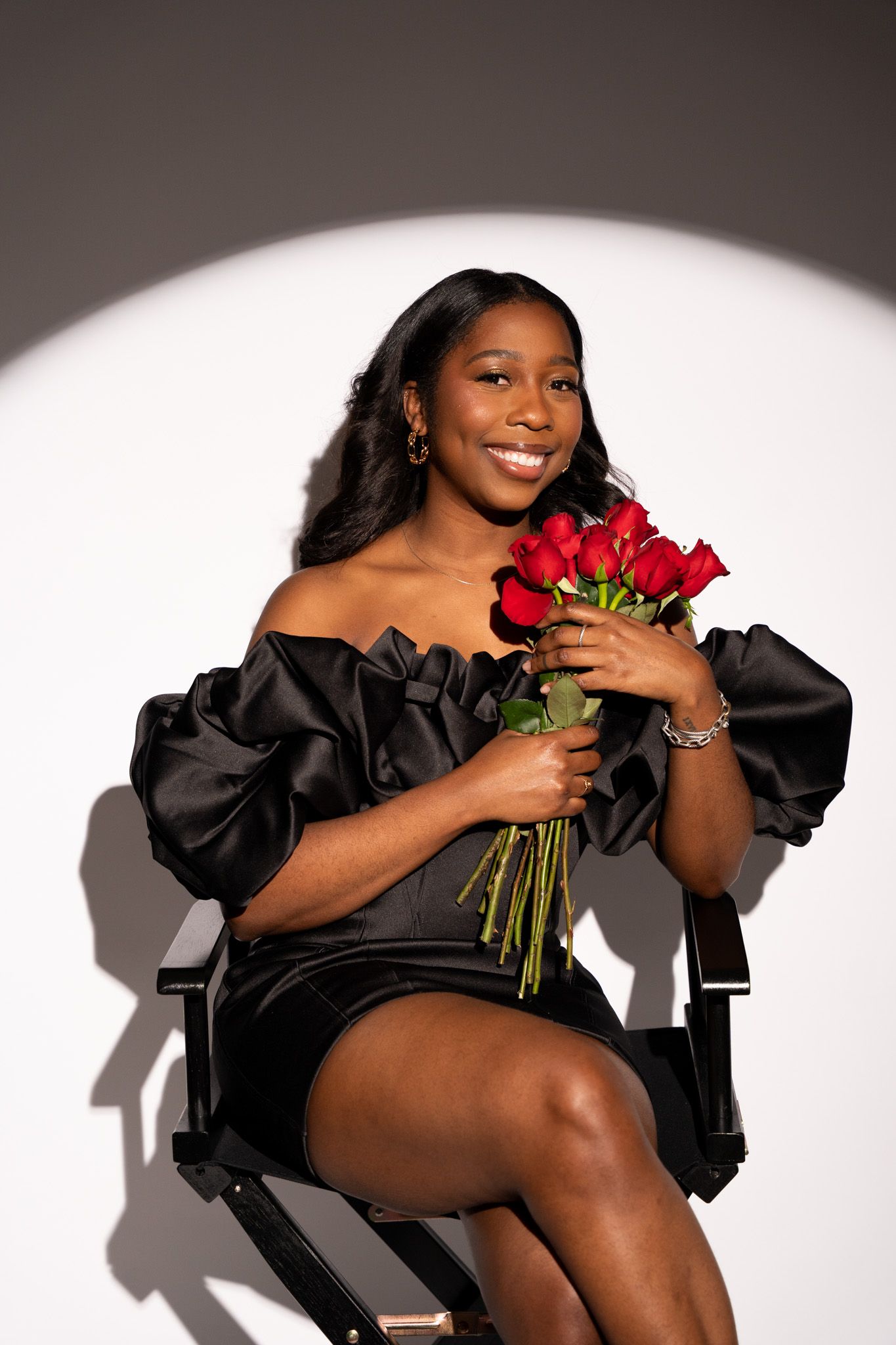 Artistic fashion portraits with red roses against a white backdrop featuring dramatic black clothing.