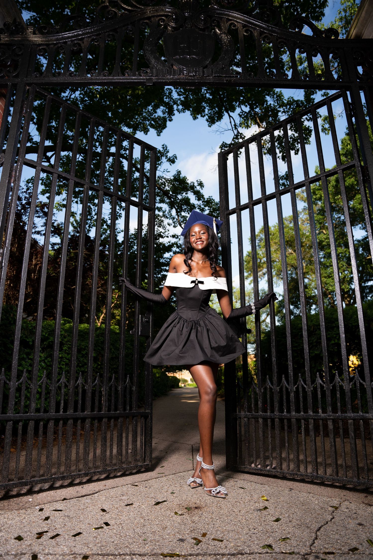 Artistic photo sequence showing dance movements near ornate metal gates in natural lighting.