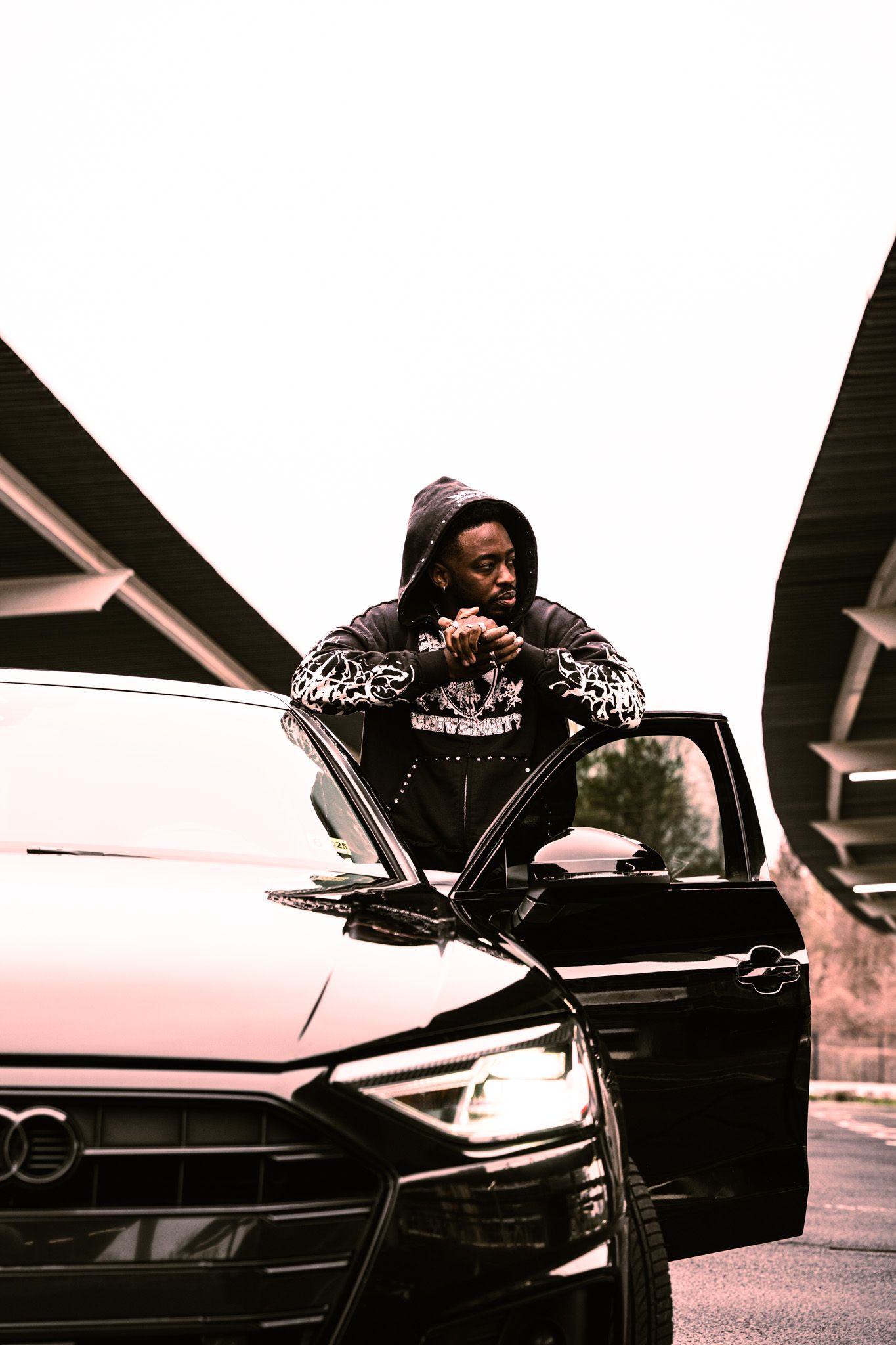 A black and white photo sequence shows someone getting into a luxury car across multiple frames.