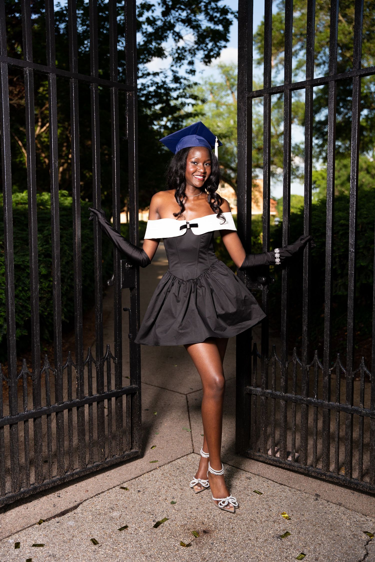 Dynamic poses captured against black iron gates in an outdoor setting.