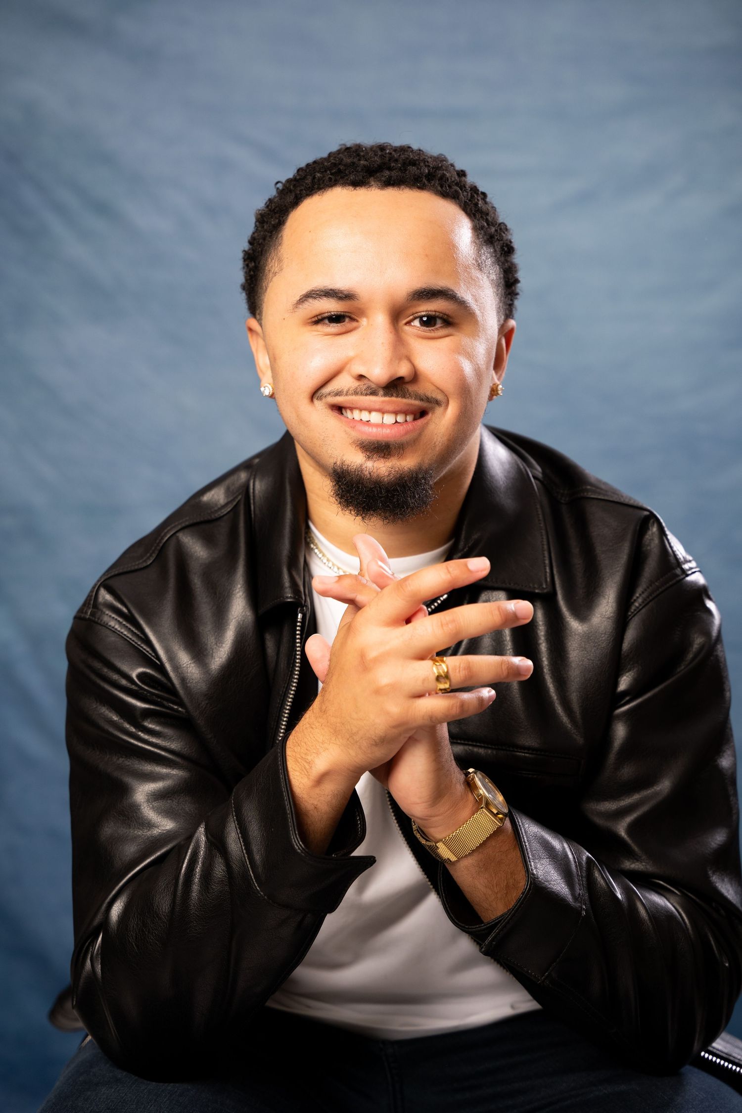 Series of casual portraits showing someone in leather jacket making playful expressions.