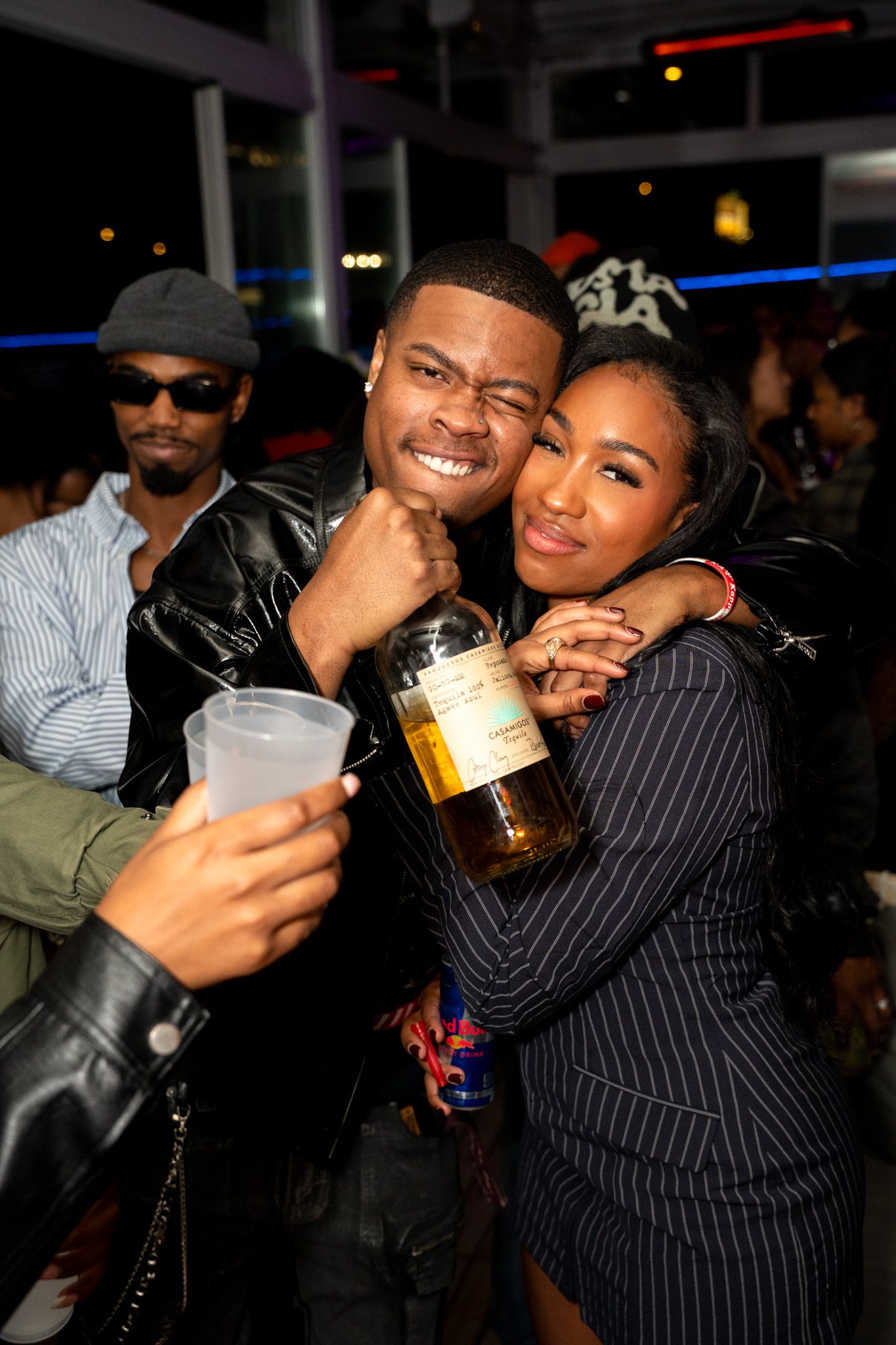 Friends enjoying drinks and socializing at a nightclub.