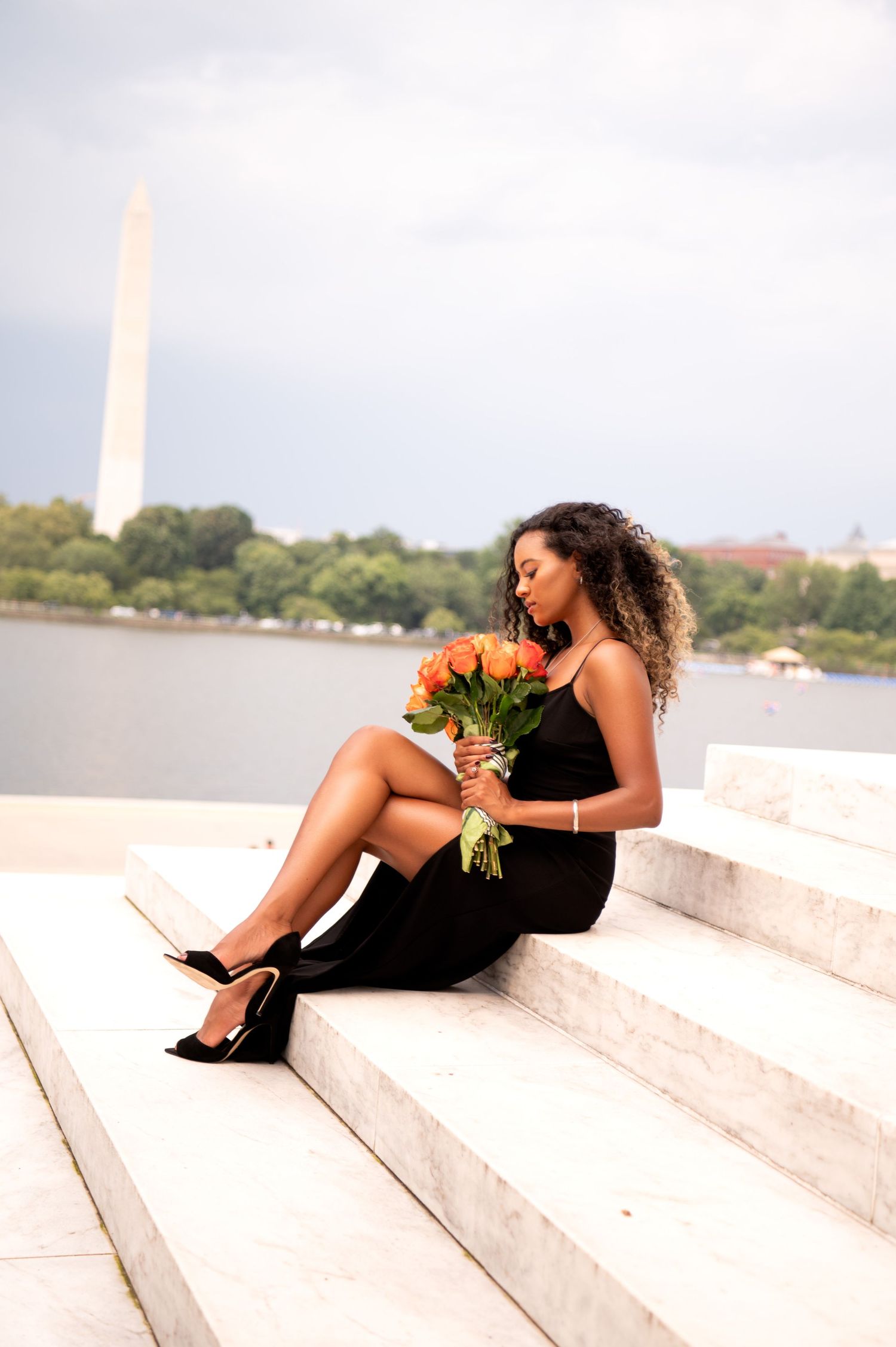 Portrait series on white steps with Washington Monument visible in background.