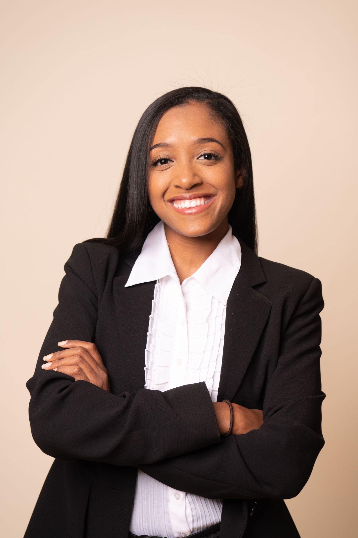 Professional portrait series of someone in business attire smiling against neutral backdrop.