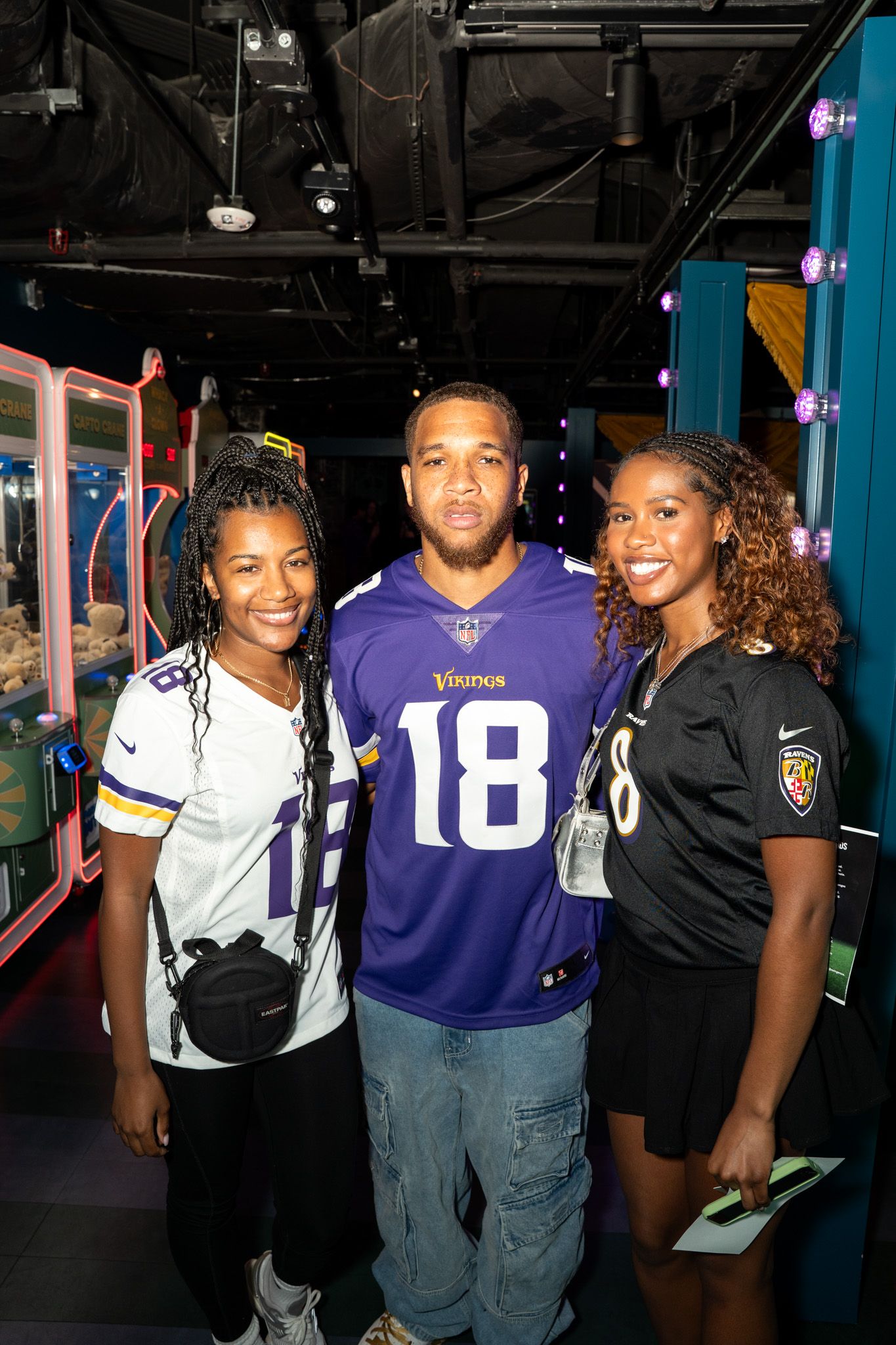 Group photo at an entertainment venue with someone wearing a Vikings jersey.
