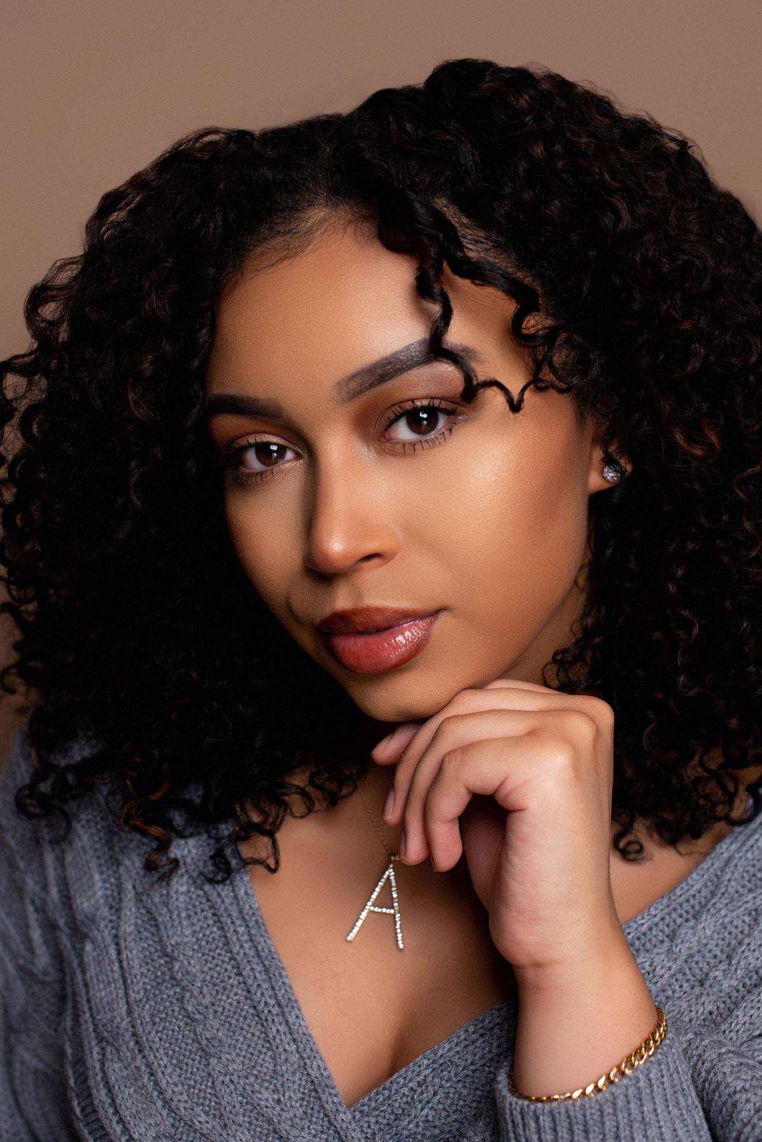 Close-up portrait series with soft lighting and delicate jewelry details.
