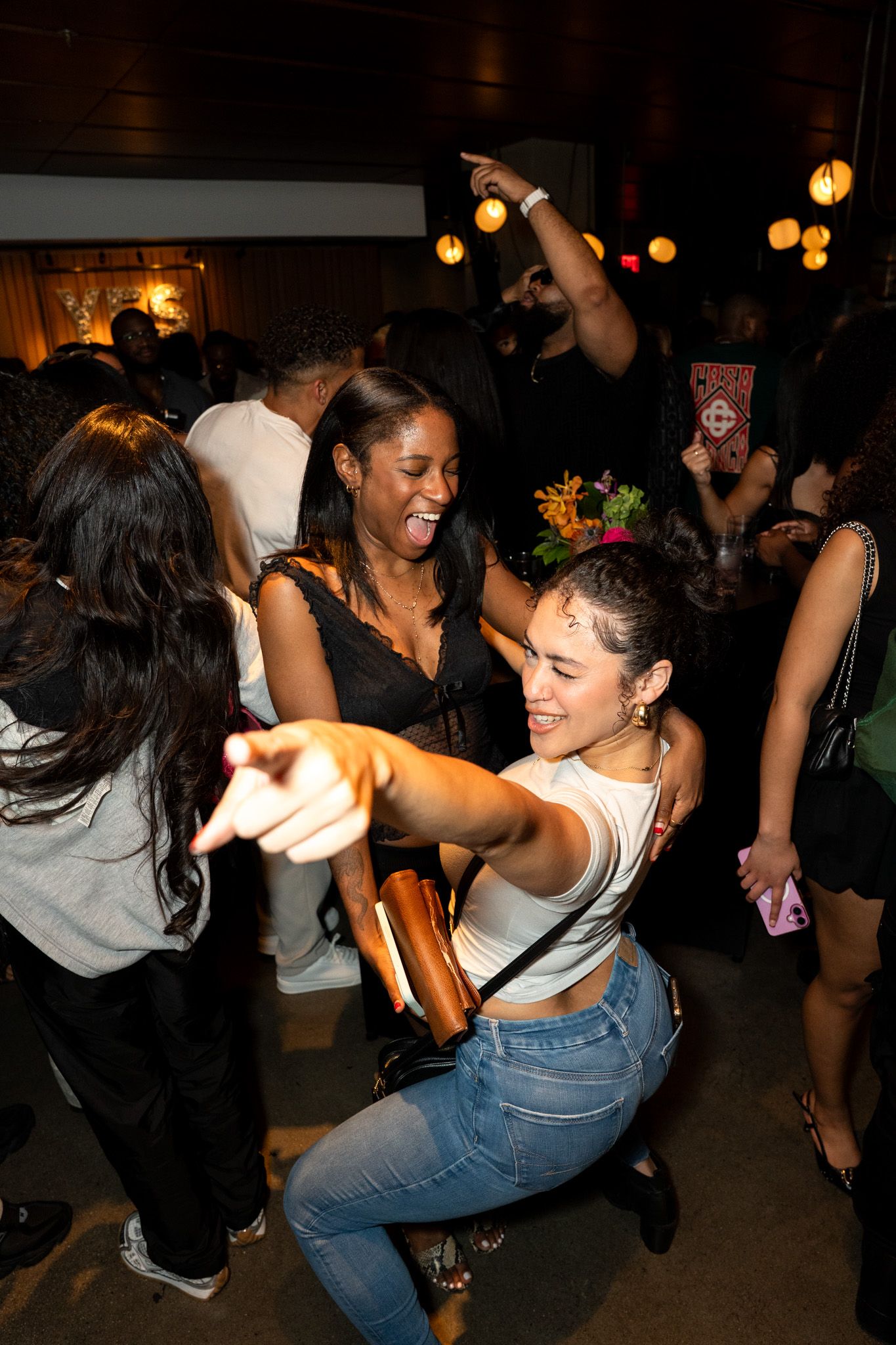 People dancing and enjoying themselves at a lively indoor party.