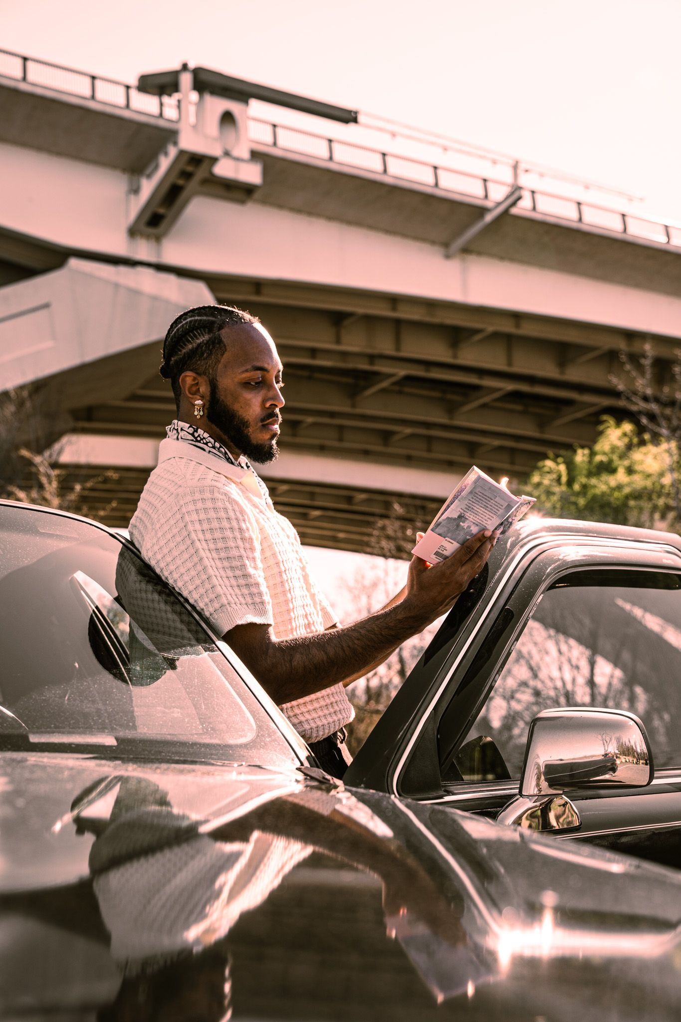 Sequence of images showing someone in a white shirt driving a car during golden hour lighting.