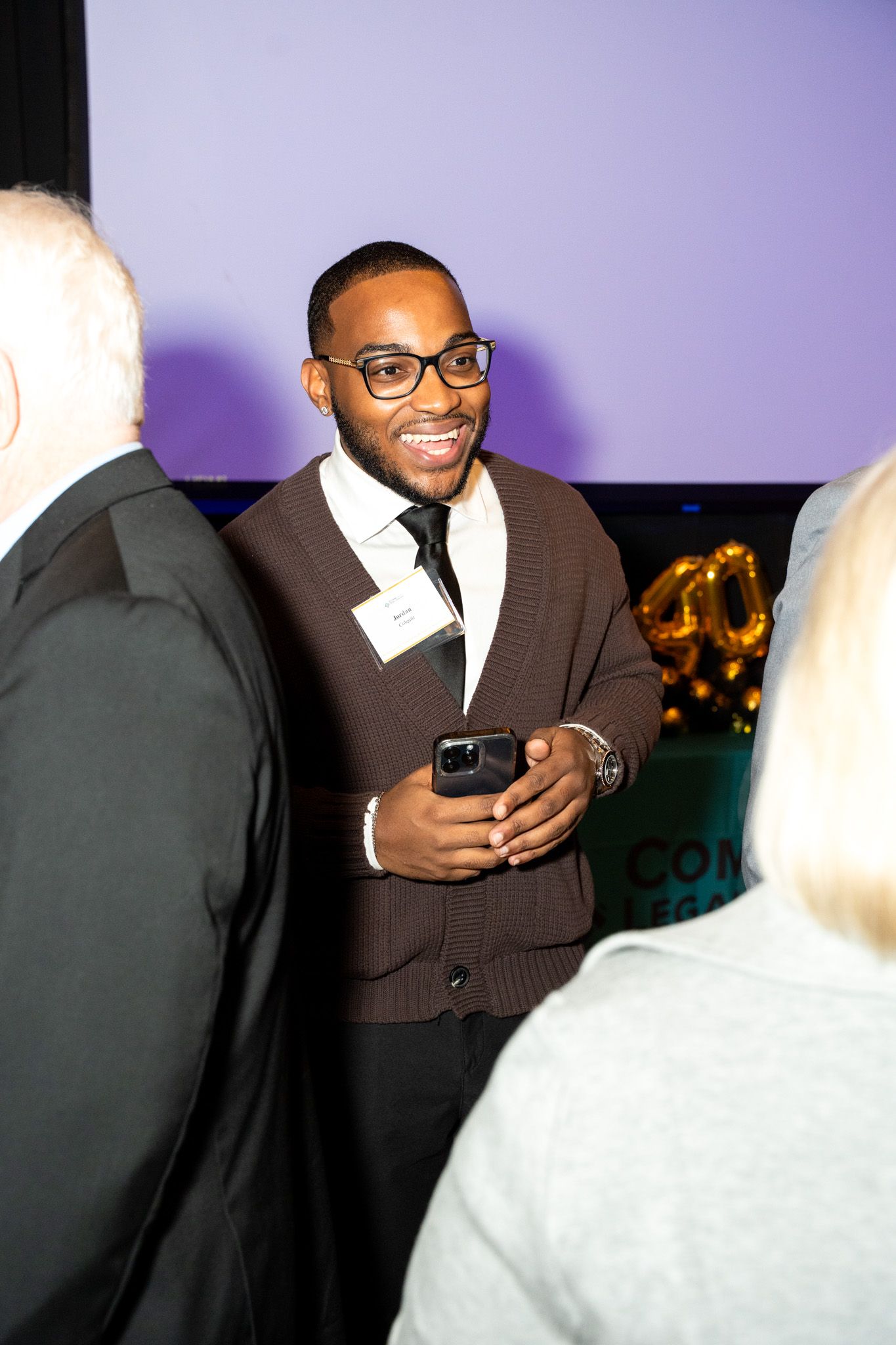 Professional networking event with attendees engaged in conversation.