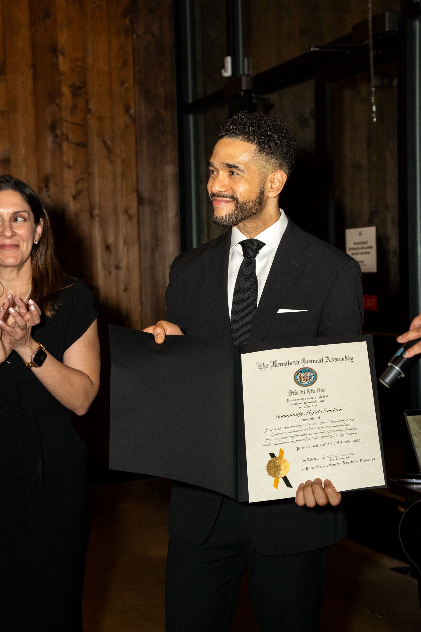 Someone displays certificates and awards at a formal recognition ceremony.