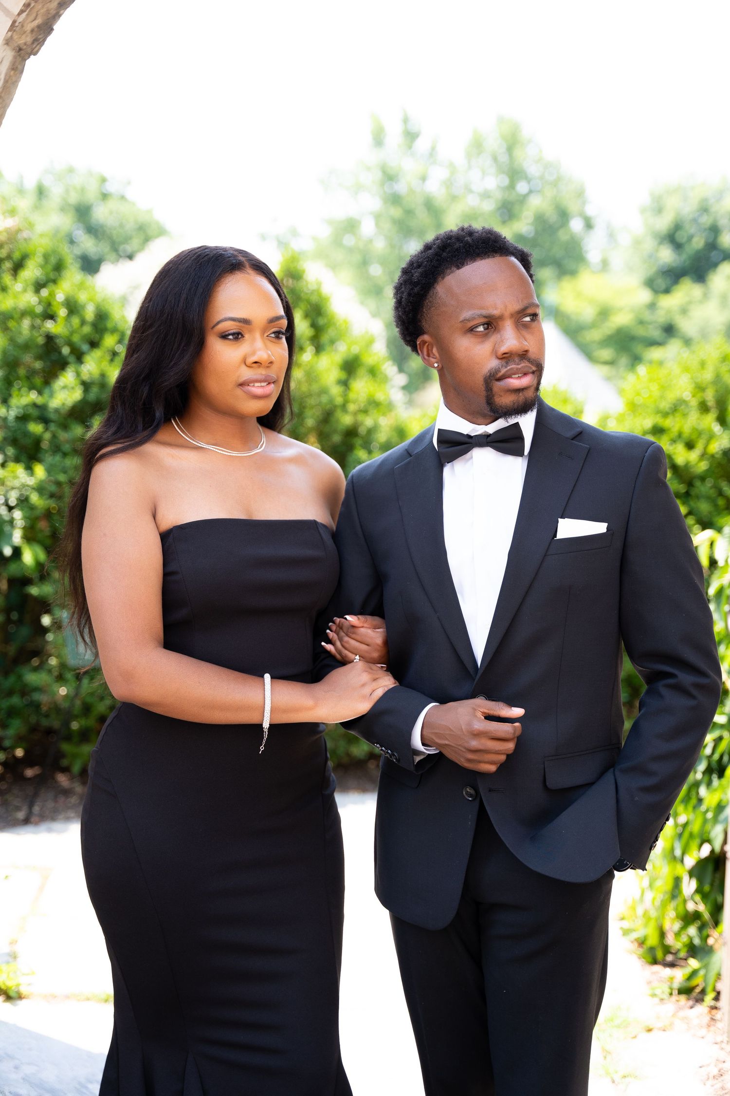 Formal couple portraits in black tie attire against outdoor garden setting.
