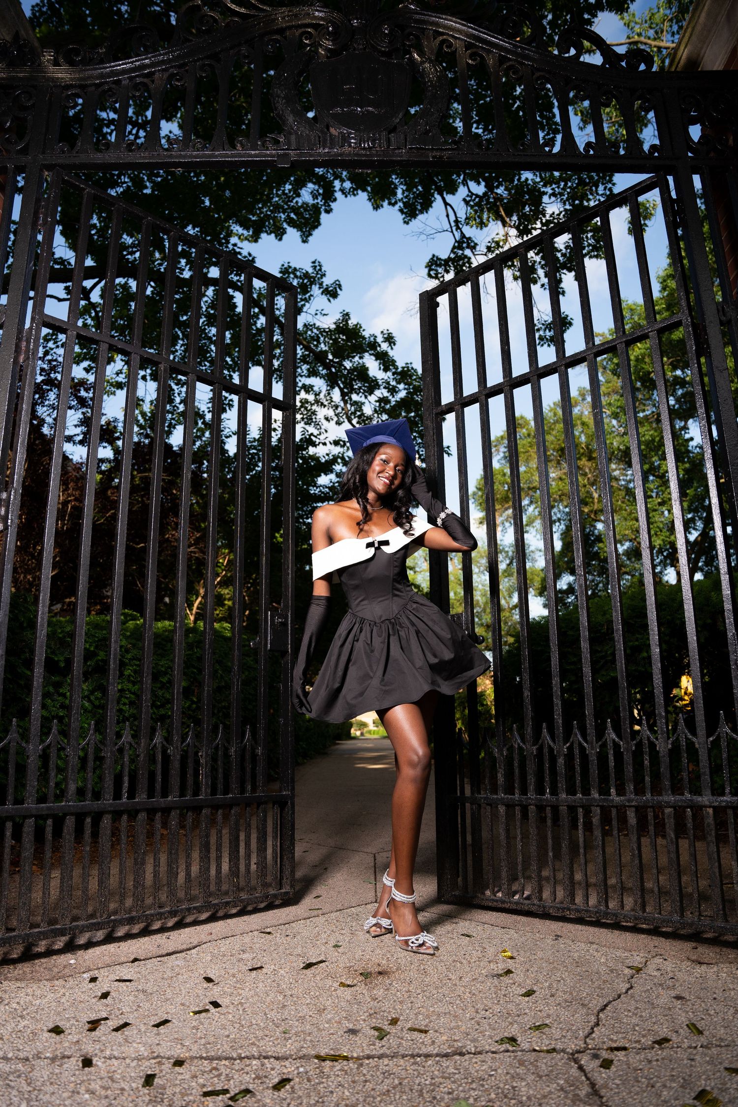 Dynamic poses and movements captured in sequence near a decorative iron gate entrance.