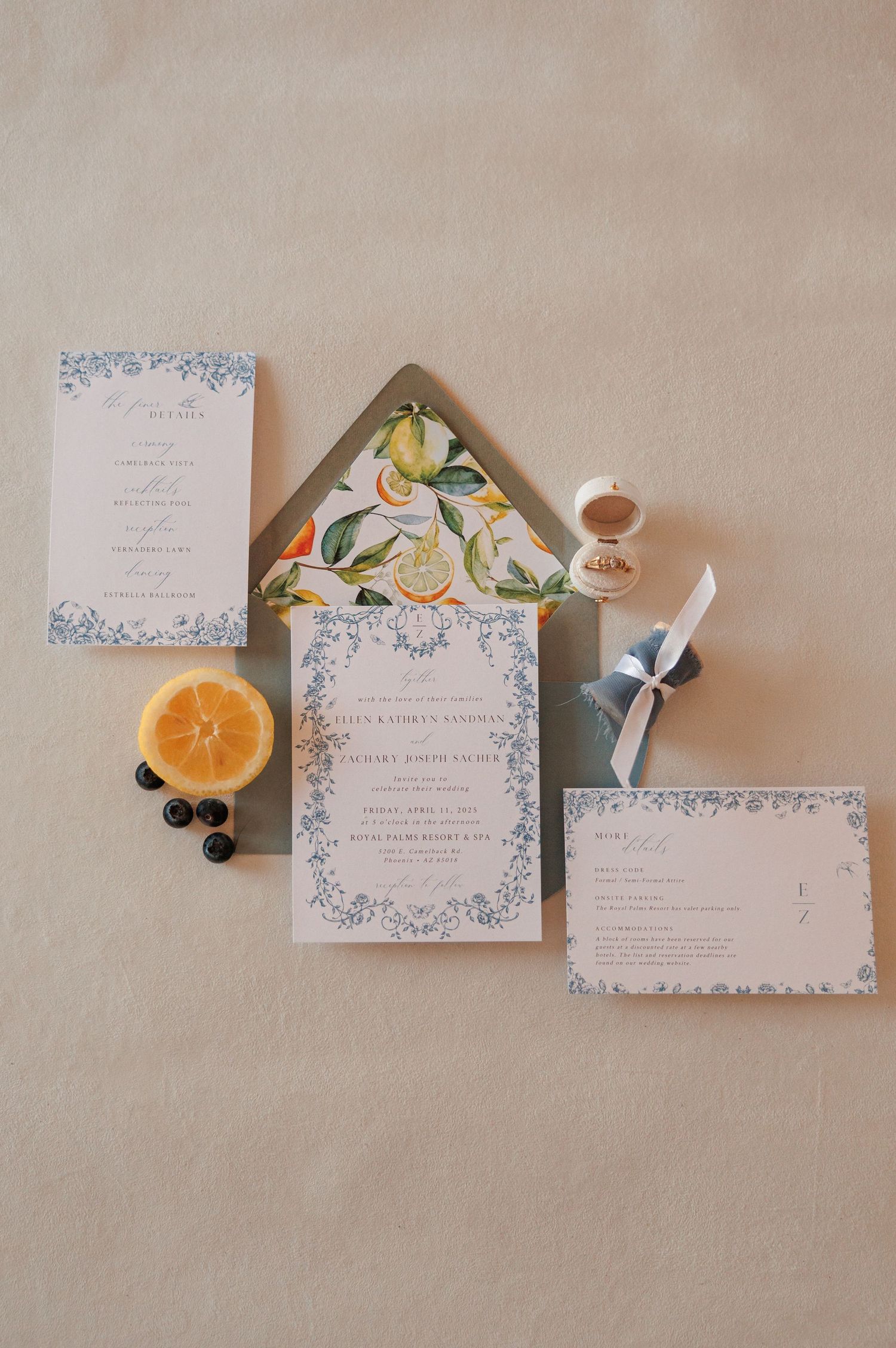 Arizona wedding invitations styled with flowers and rings on table