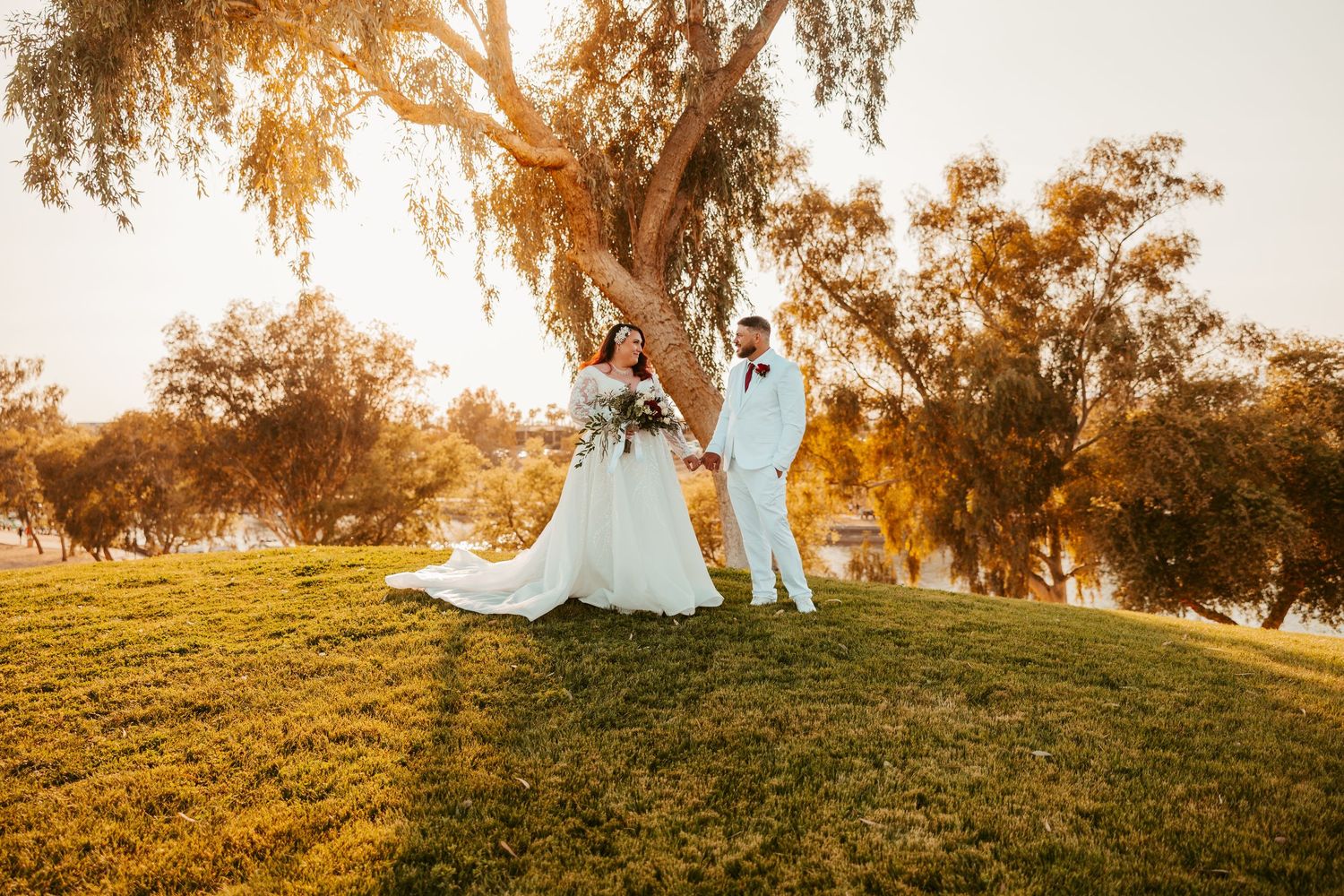 Bride and groom holding hands under desert sunset in Lake Havasu City, Arizona