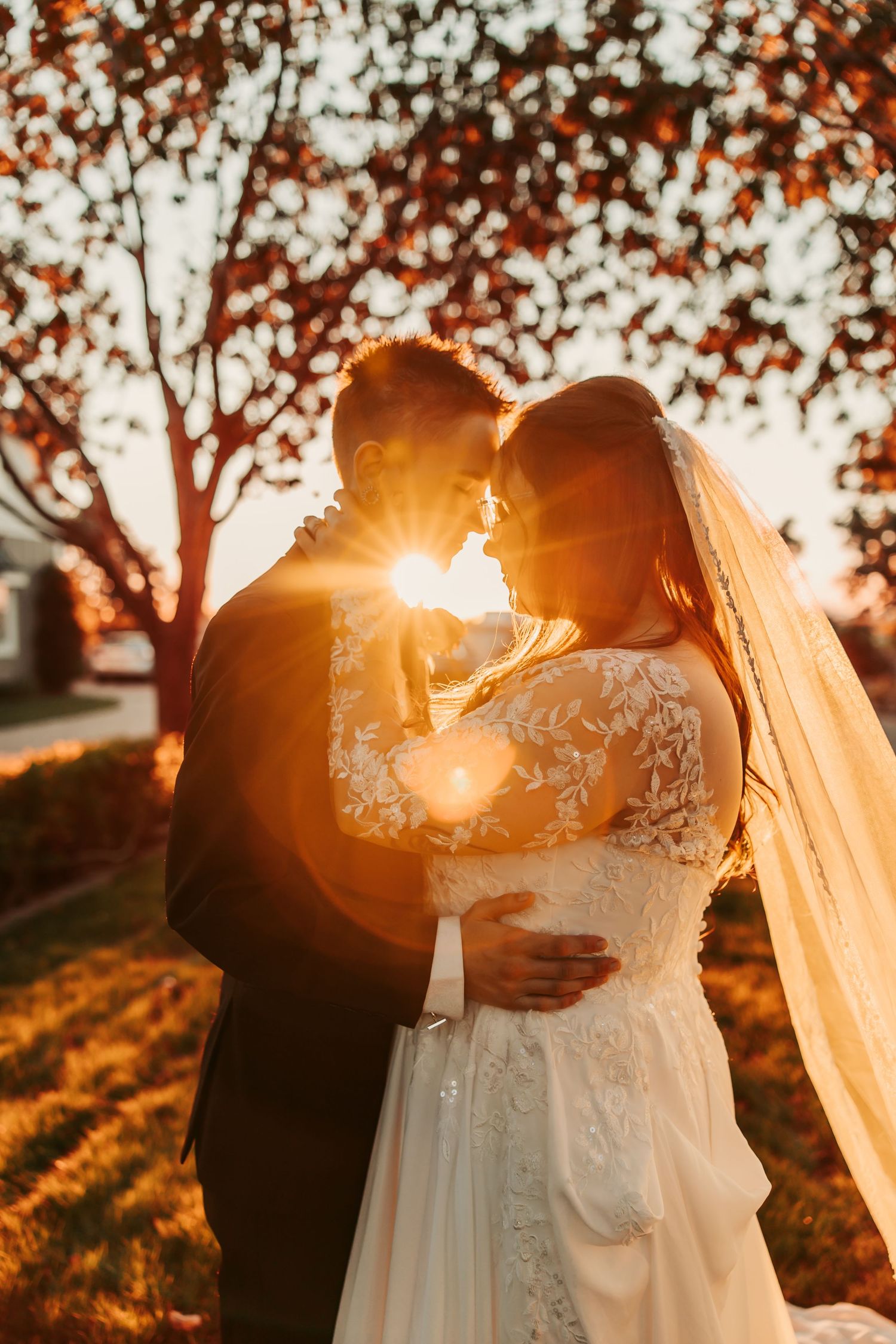 Destiny and Kinley embracing each other after their Phoenix Arizona wedding ceremony in the desert sunset.