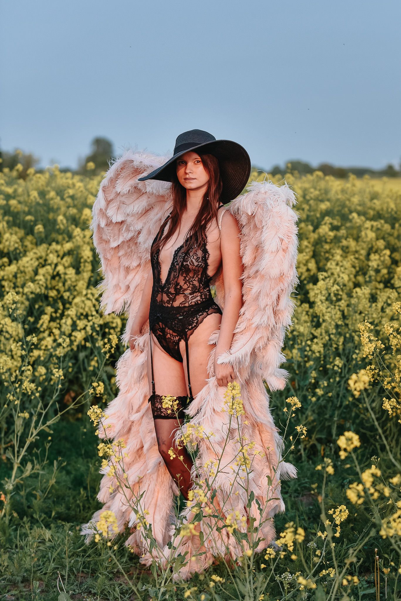 Wild & free boudoir fotografering med änglavingar i rapsfält