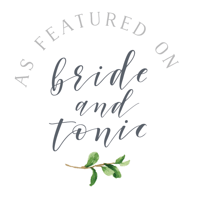 Elegant calligraphy logo design featuring 'bride and tonic' text with a delicate green watercolor leaf sprig accent.