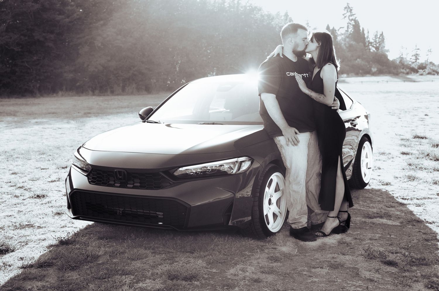 Black and white photography series featuring couple posing with luxury car.