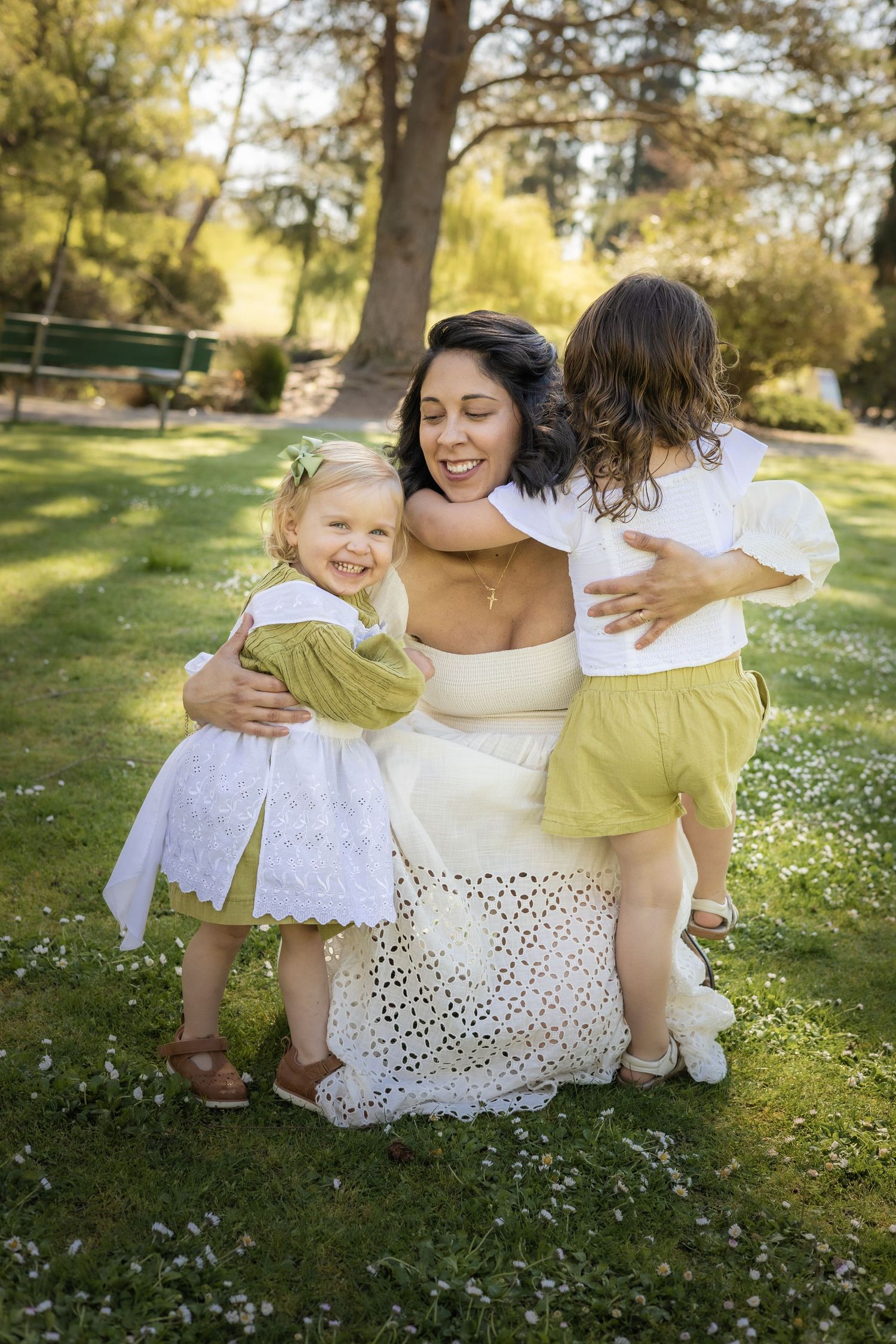Family portrait session in park with white and yellow spring outfits.