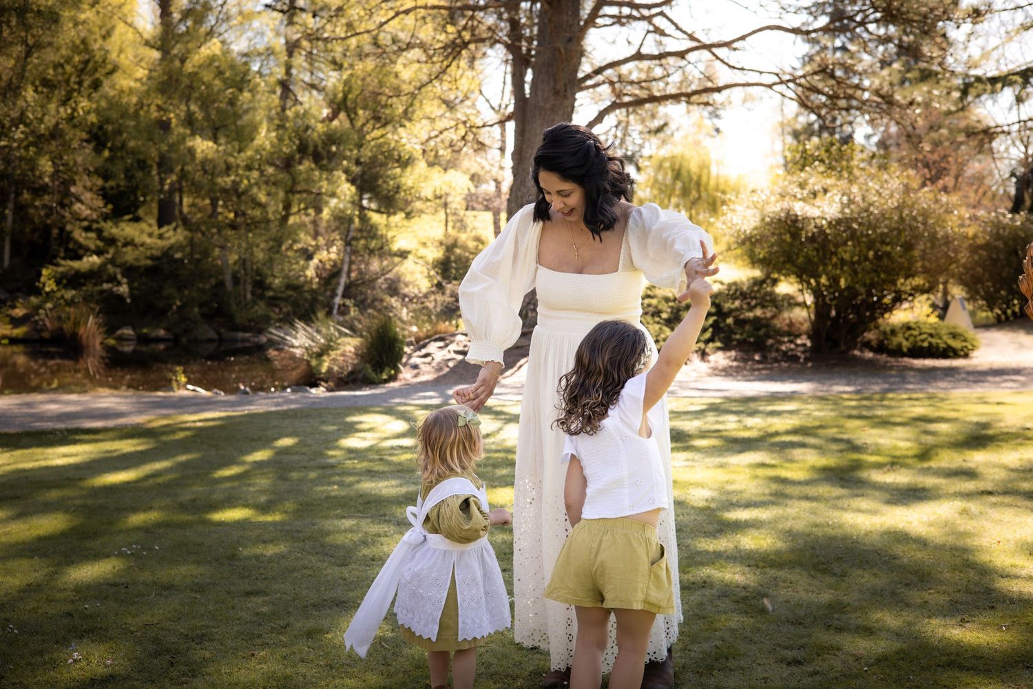 Candid family moments captured in sunny garden setting.