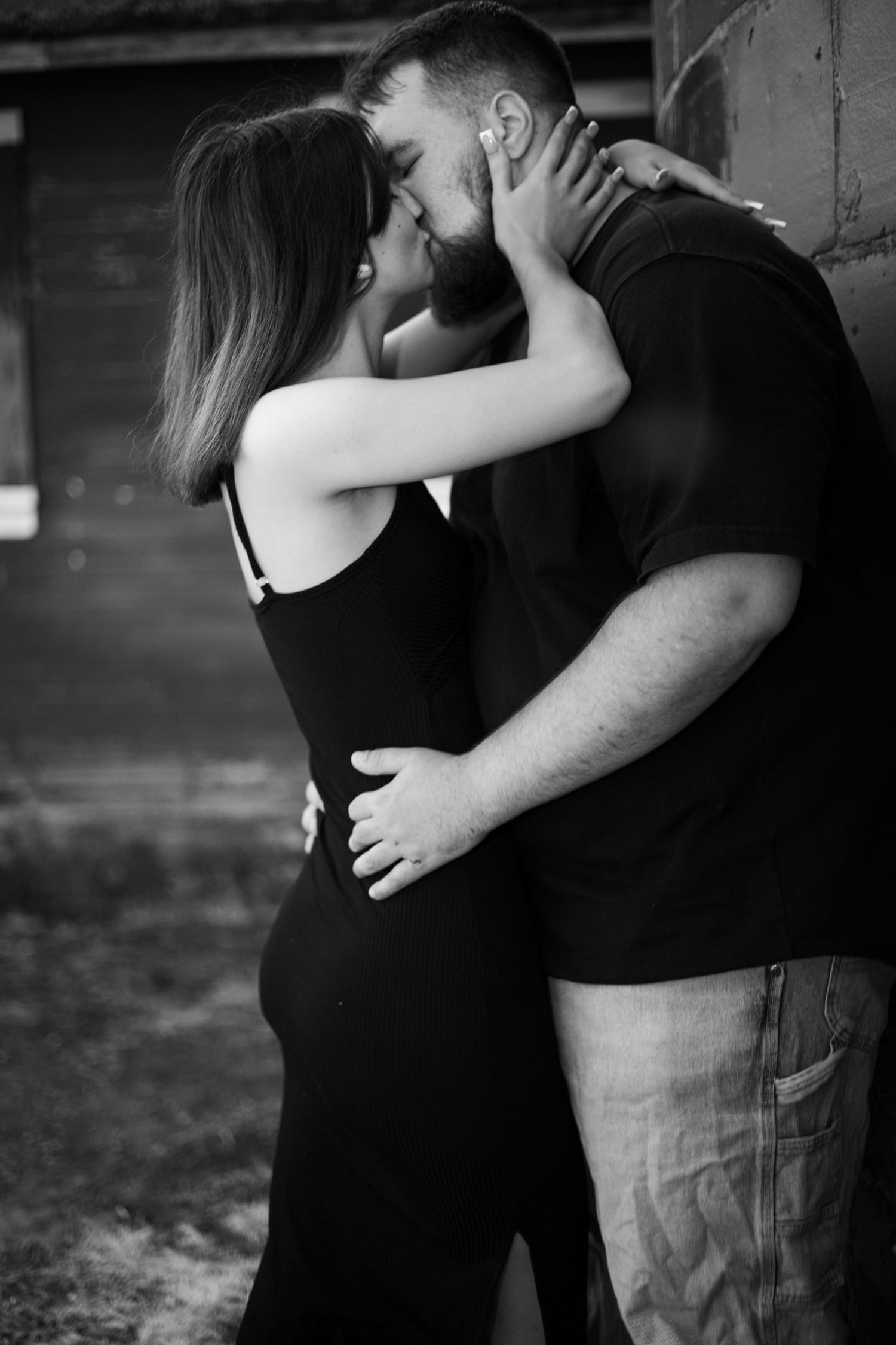 Black and white portrait captures intimate moment between couple.