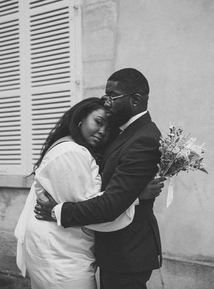 An intimate black and white portrait of a couple embracing during their wedding day.