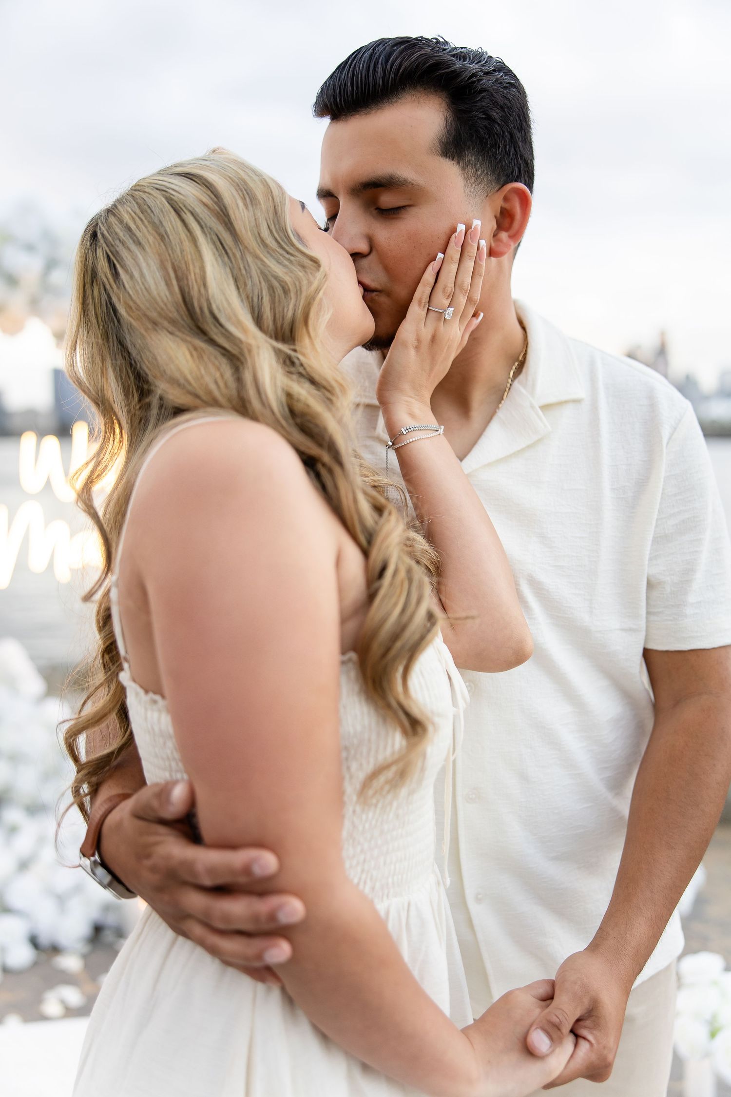 A couple in white outfits sharing intimate romantic moments in a series of romantic photos.